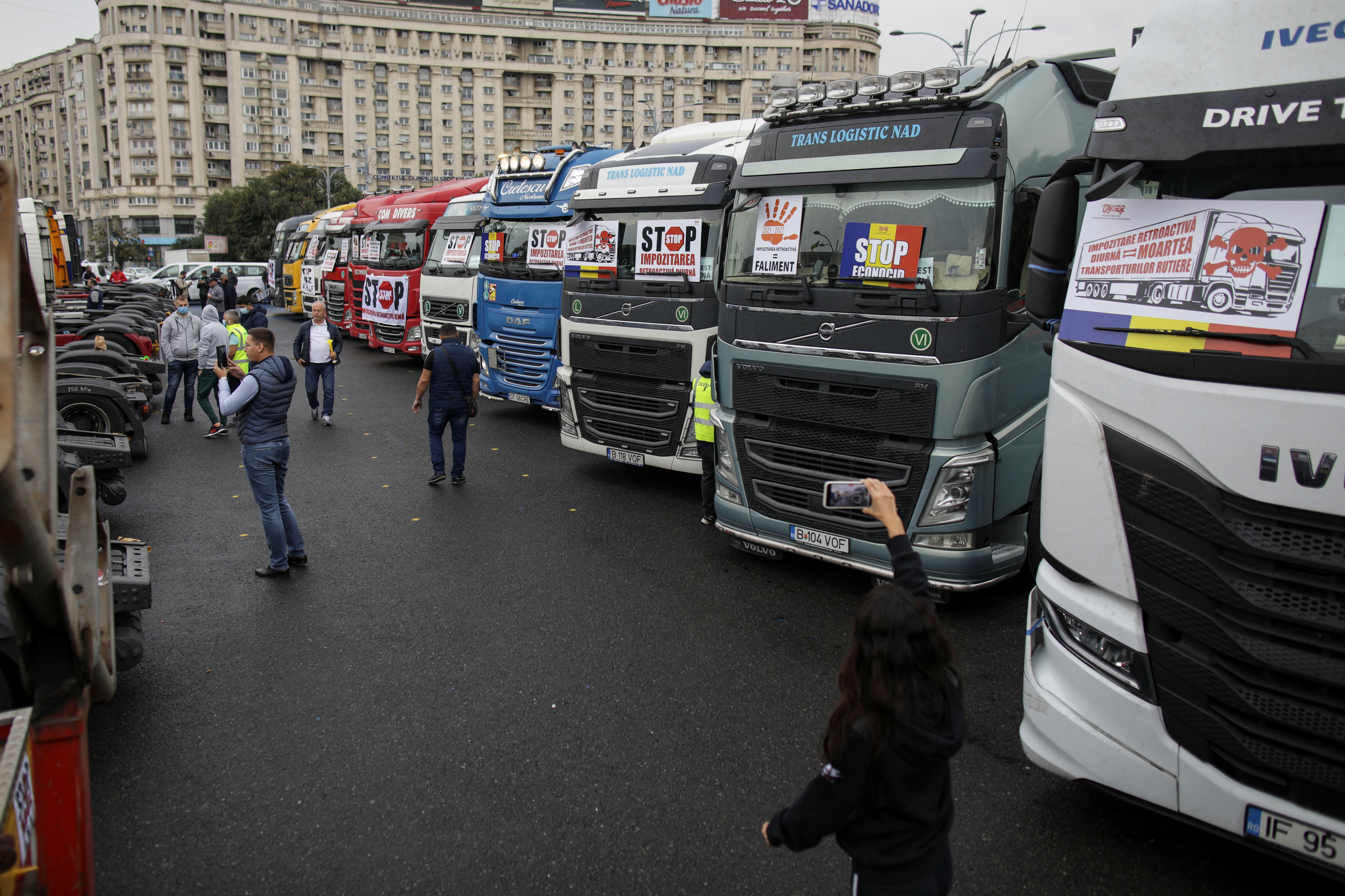 Romanian truckers protest pay cuts in front of the government headquarters in Bucharest