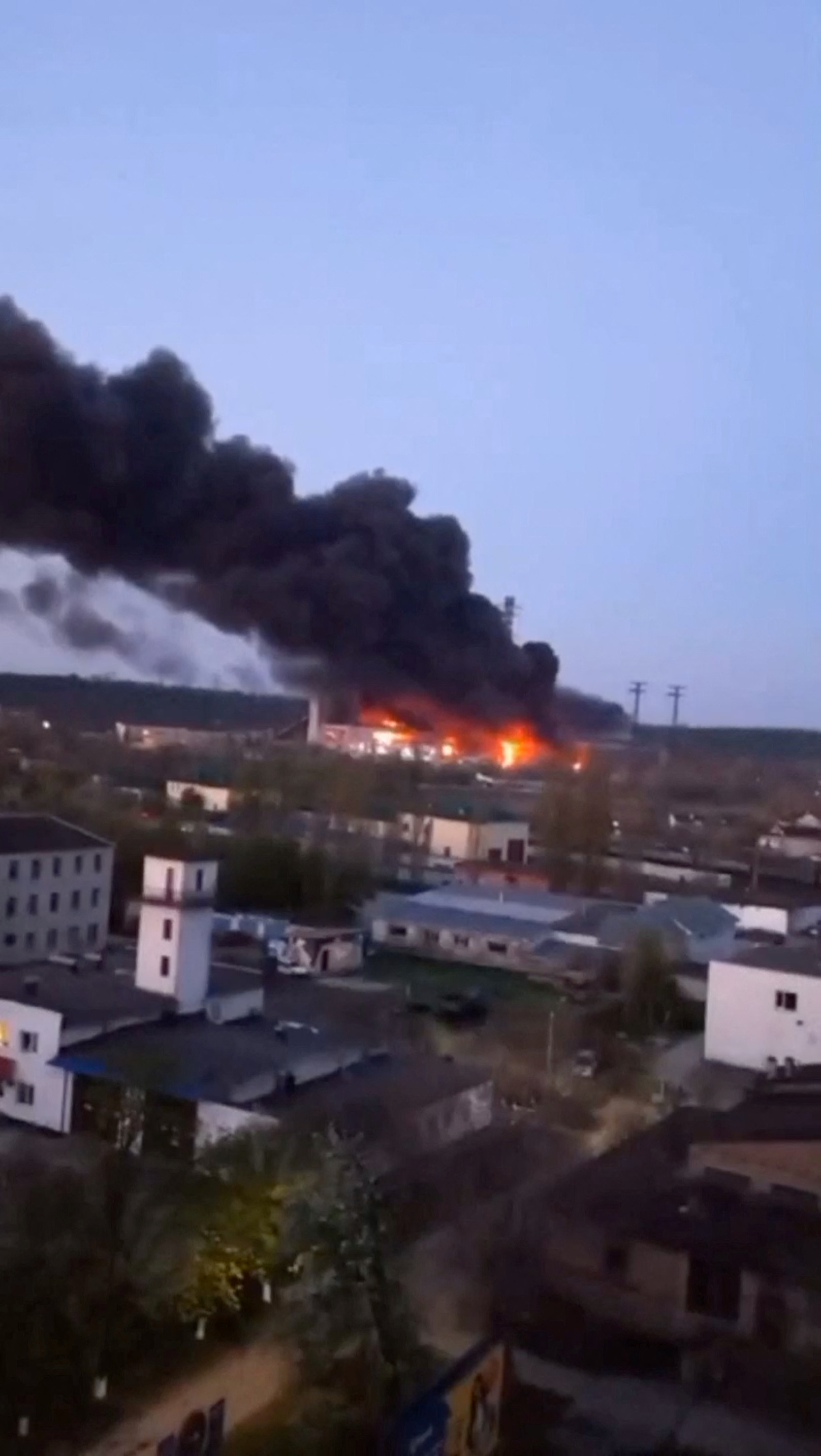 Smoke and fire rise from the site of a missile strike at the Trypilska power station in Kyiv region