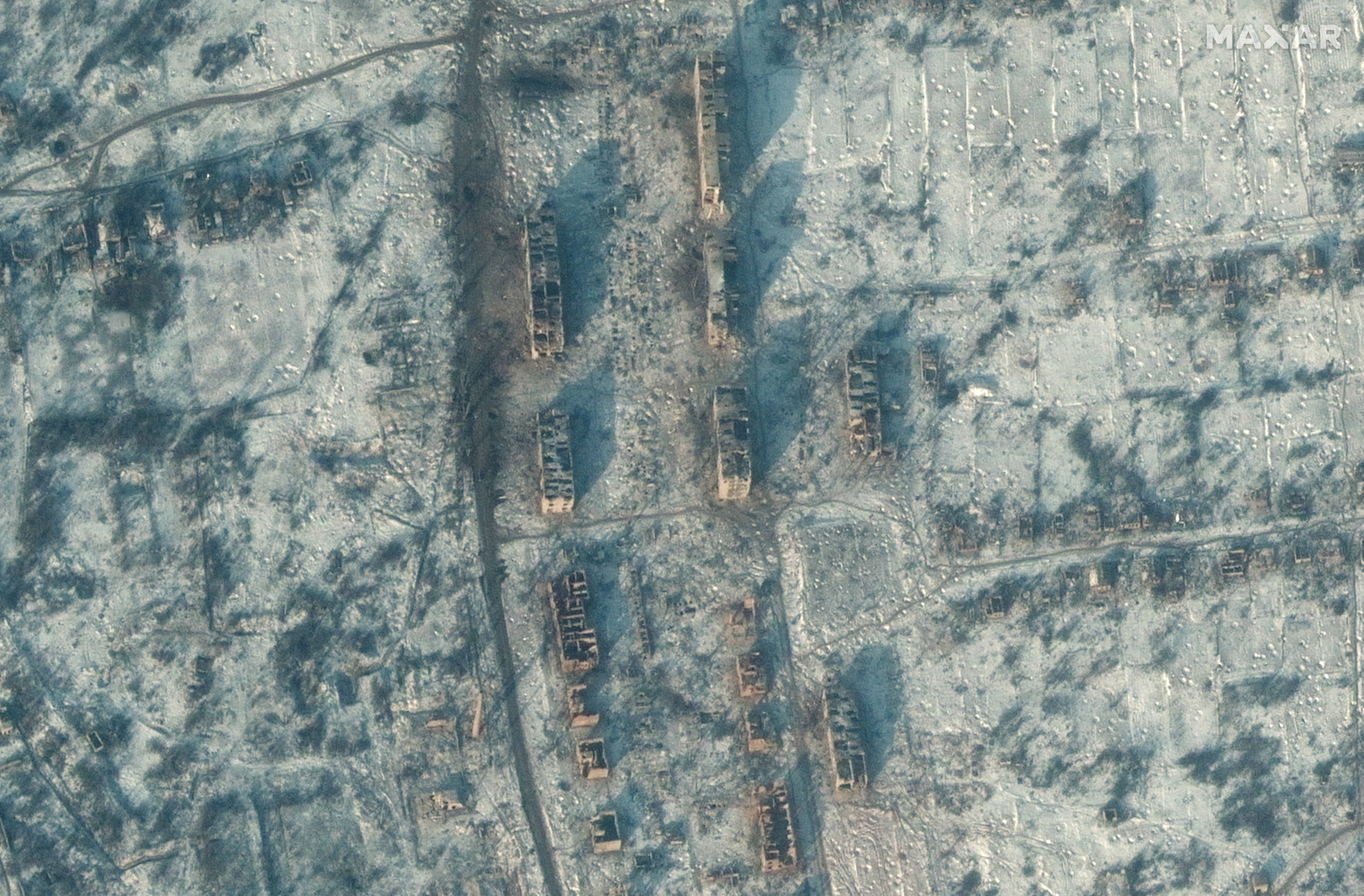 A satellite view shows destroyed apartment buildings and homes, in Soledar