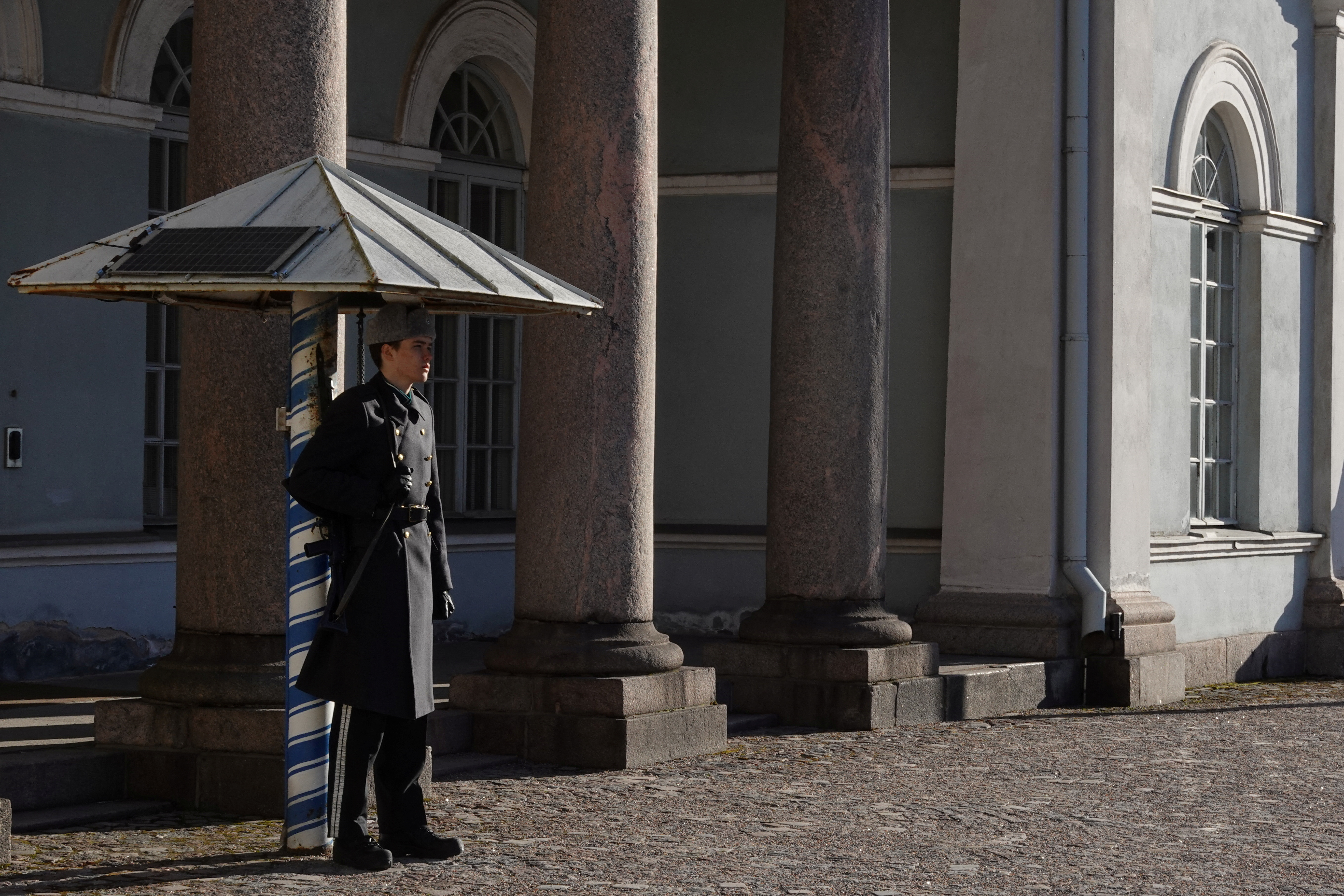 A guard stands outside the city hall, as Finland becomes a member of NATO, in Helsinki