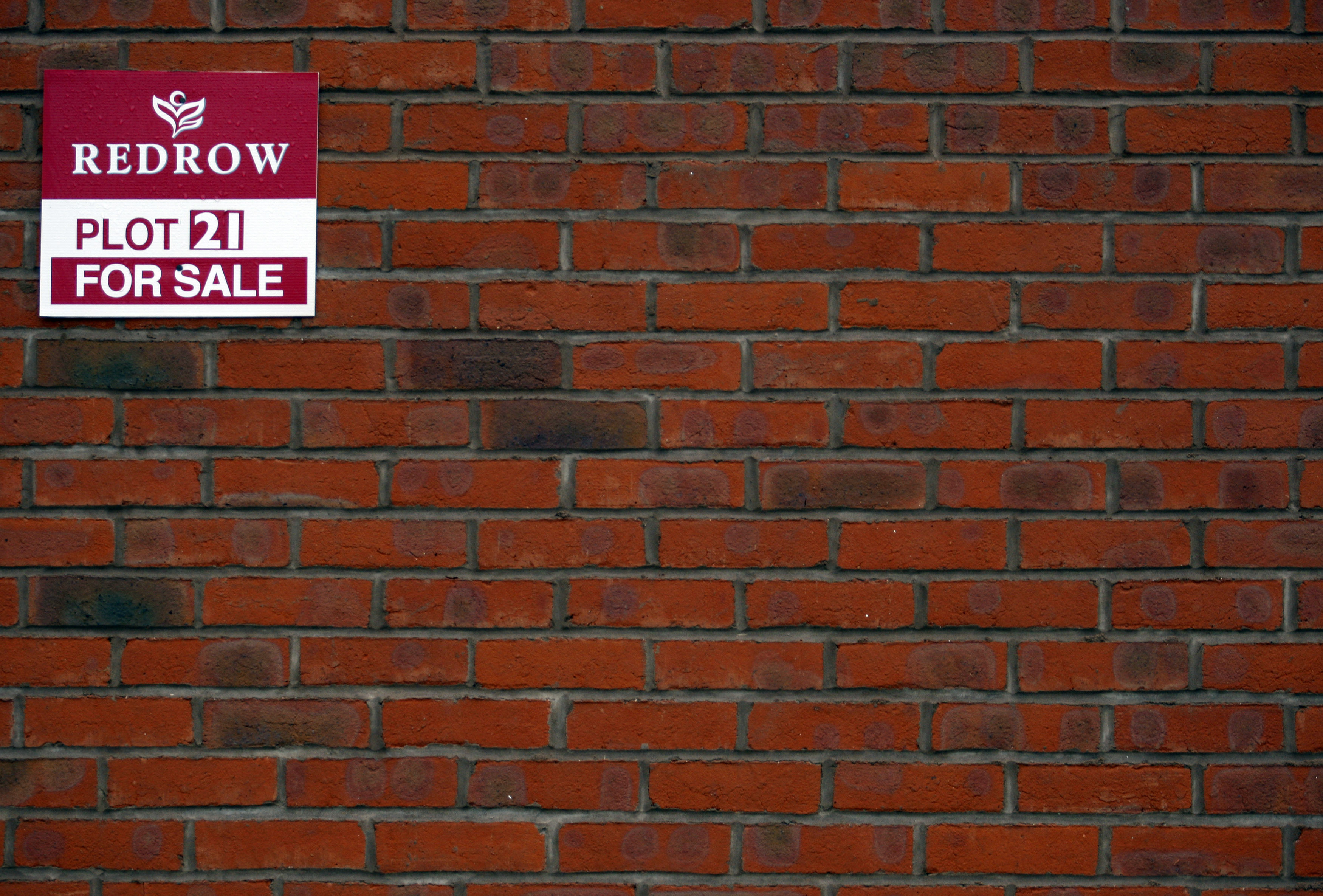 A for sale sign is seen on a house on a Redrow housing development in Church Greasly, central England