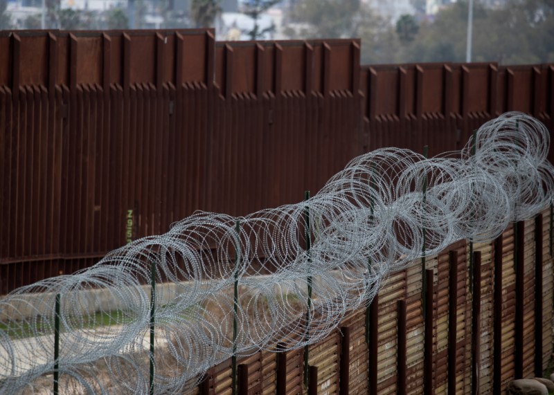 An old border wall fence is shown next to the newly constructed wall along the U.S. Mexico border next to Tijuana, east of San Diego, California