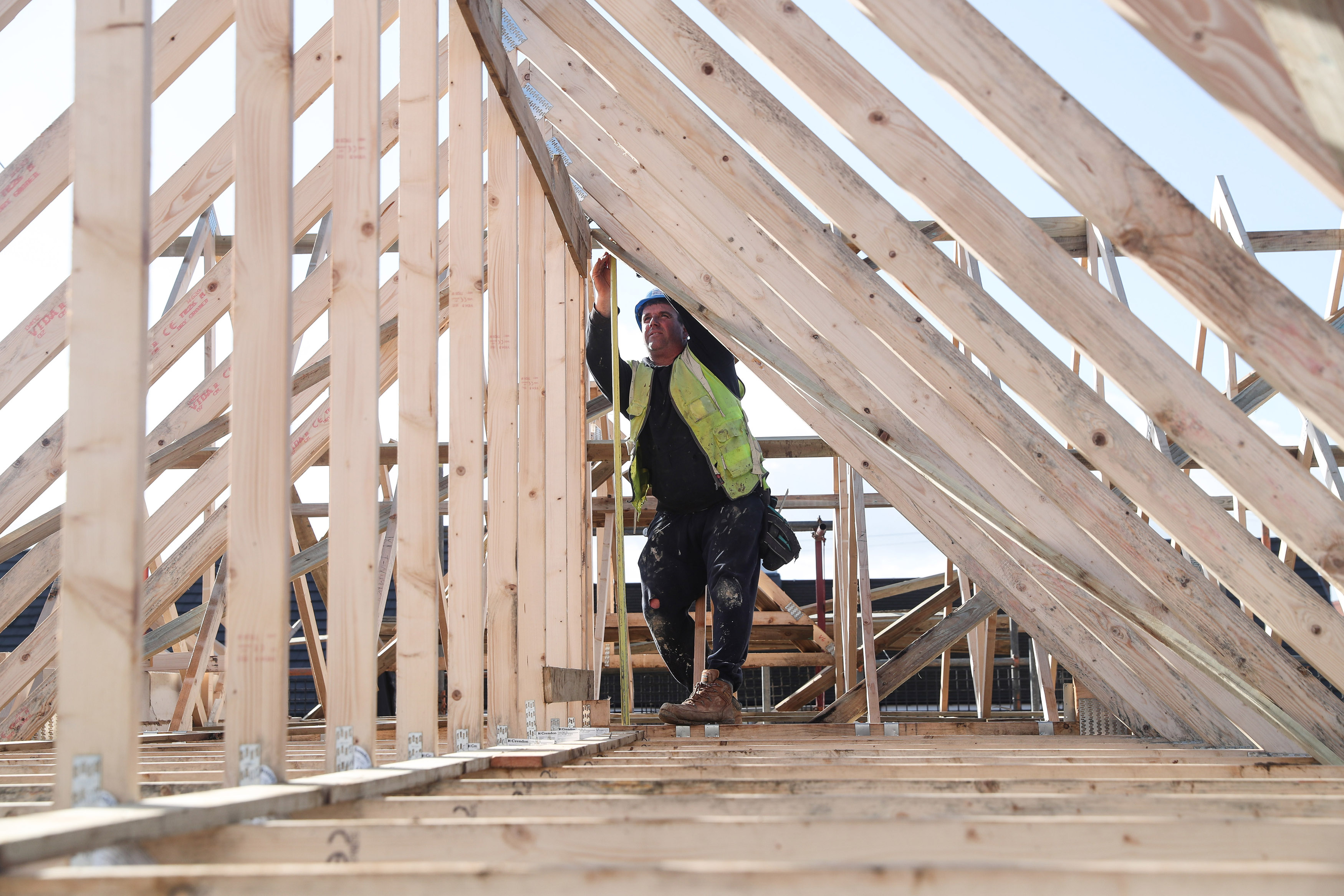 A builder working for Taylor Wimpey builds a roof on an estate in Aylesbury
