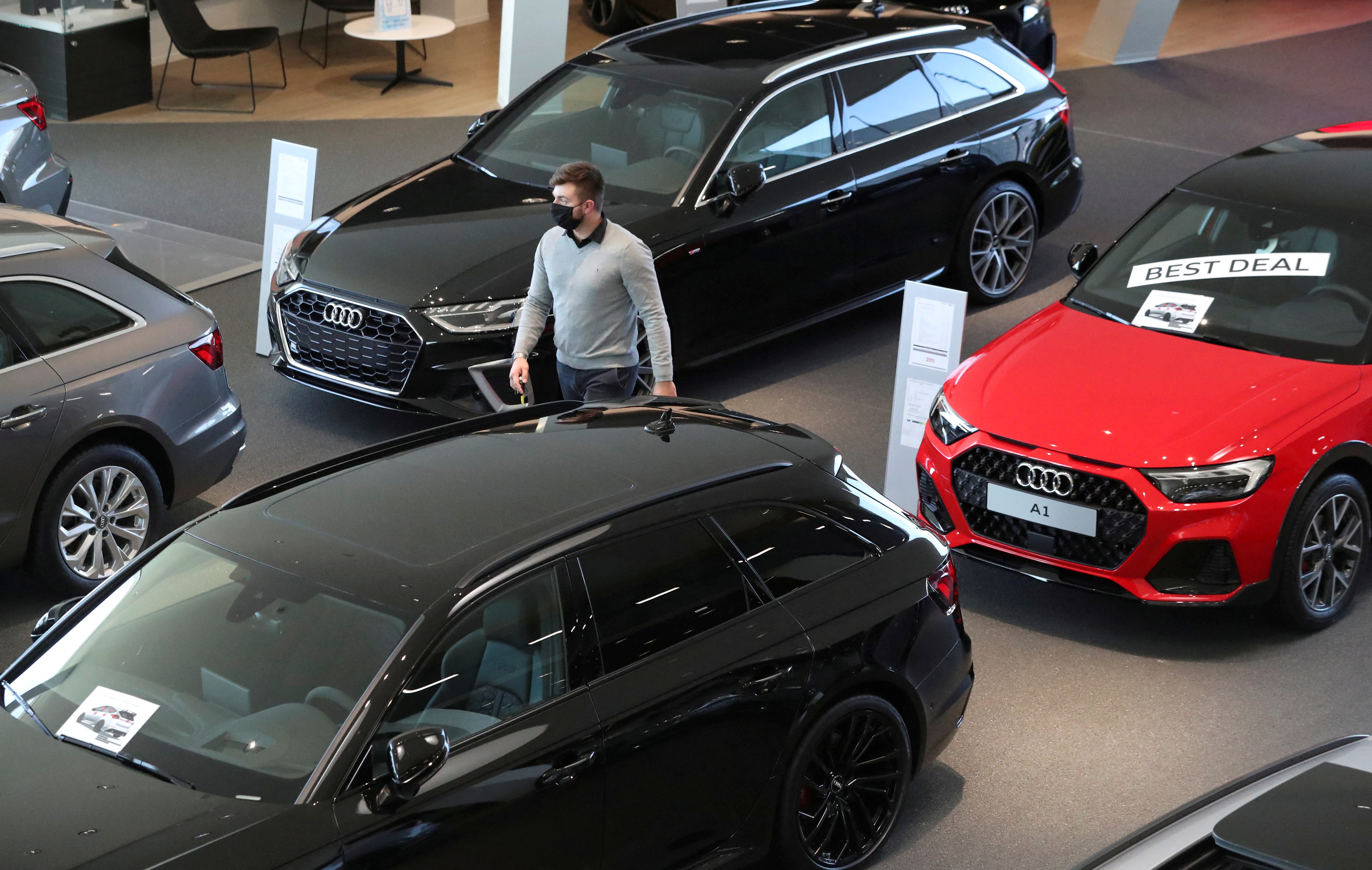 An employee at Audi Center Brussels car dealer, wearing a protective mask, is seen in the show room, amid the coronavirus disease (COVID-19) outbreak in Brussels