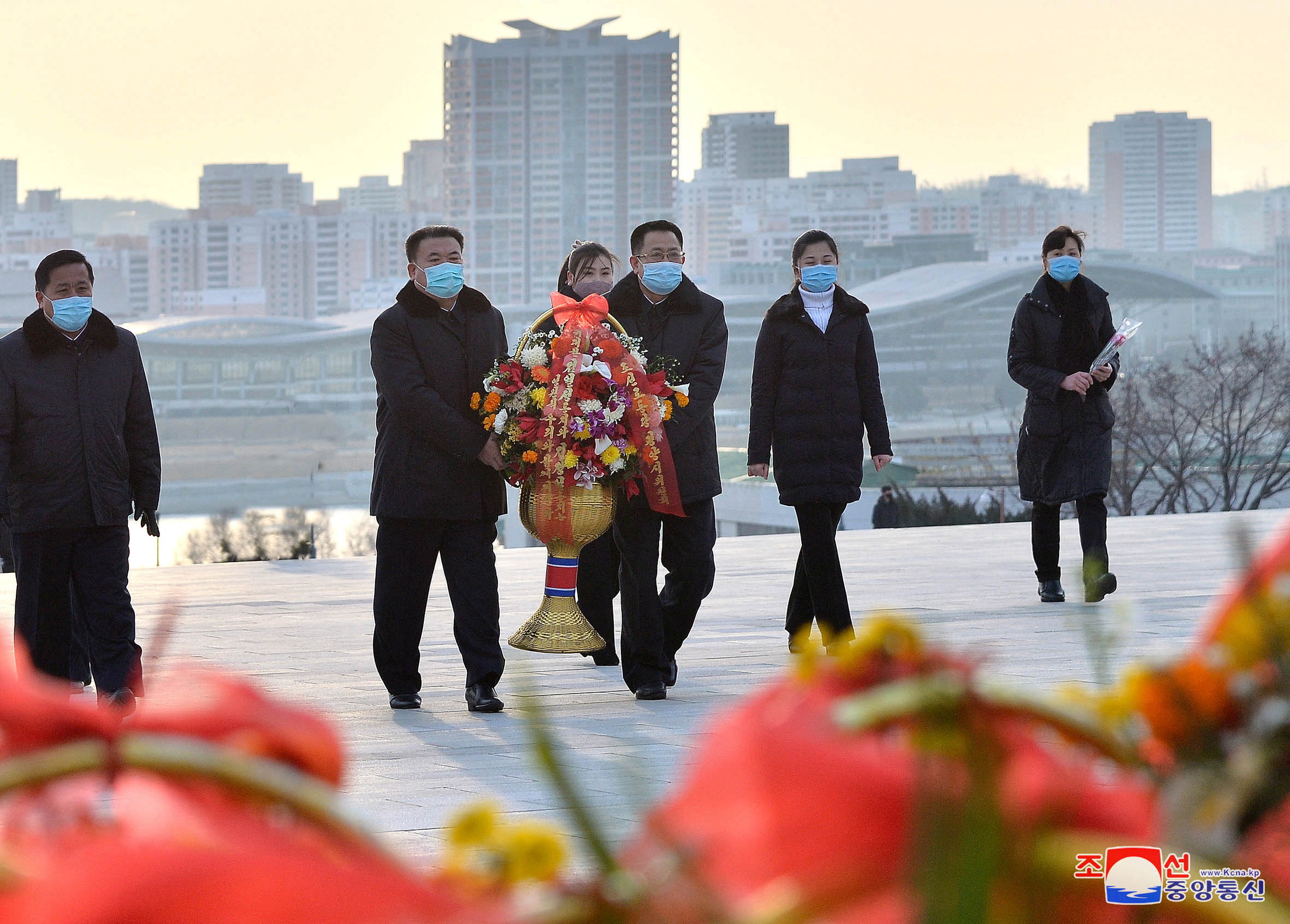 People lay floral tribute to commemorate the Day of the Shining Star, the birth anniversary of the late leader Kim Jong Il, at the Mansudae Grand Monument in Pyongyang