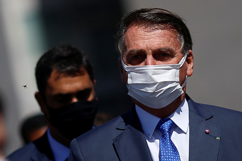 Brazil's President Jair Bolsonaro walks after a meeting to deliver the interim measure for changes in social welfare program Bolsa Familia (Family Allowance)