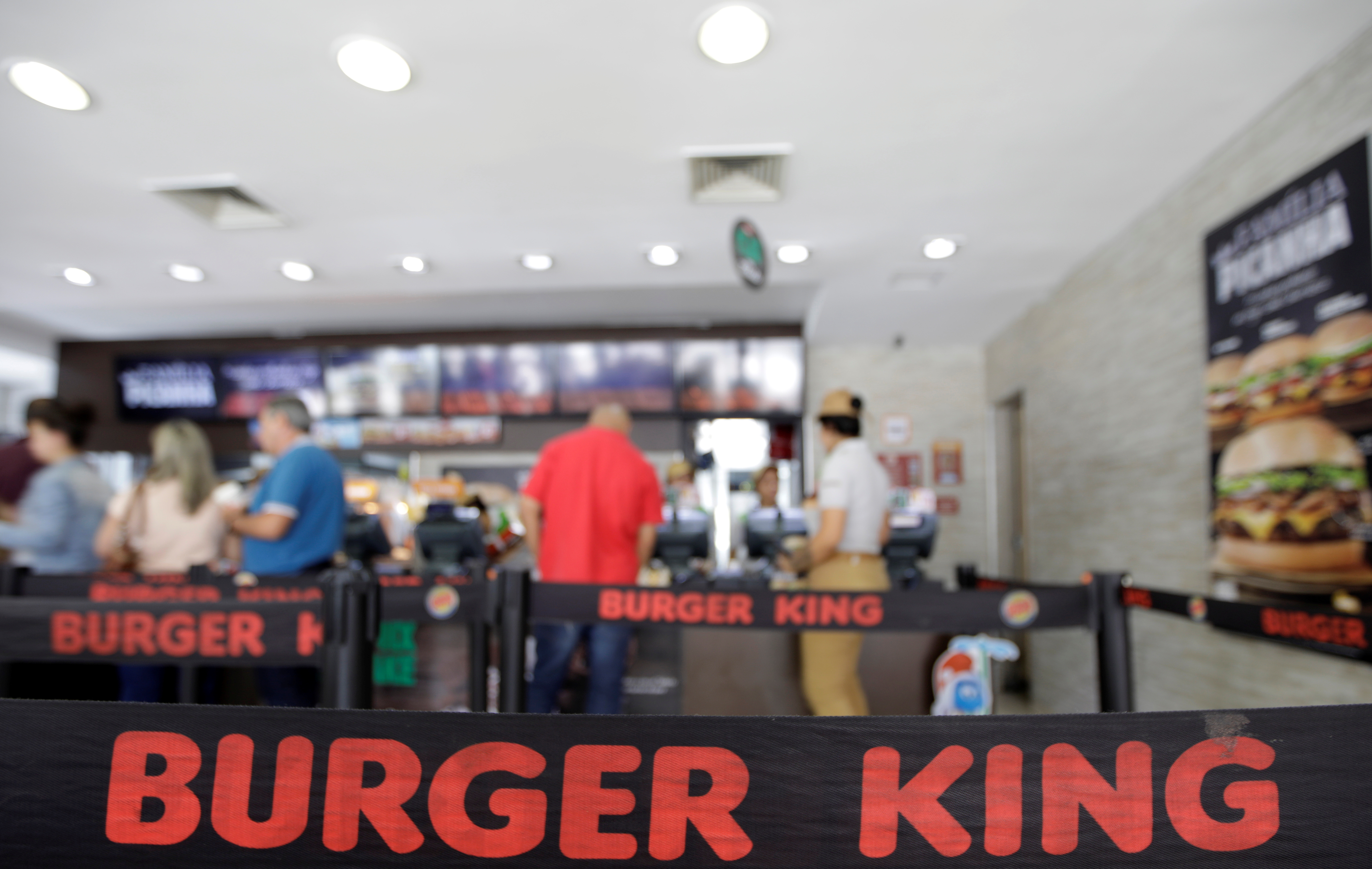 Consumers line up at a Burger King restaurant in Sao Paulo