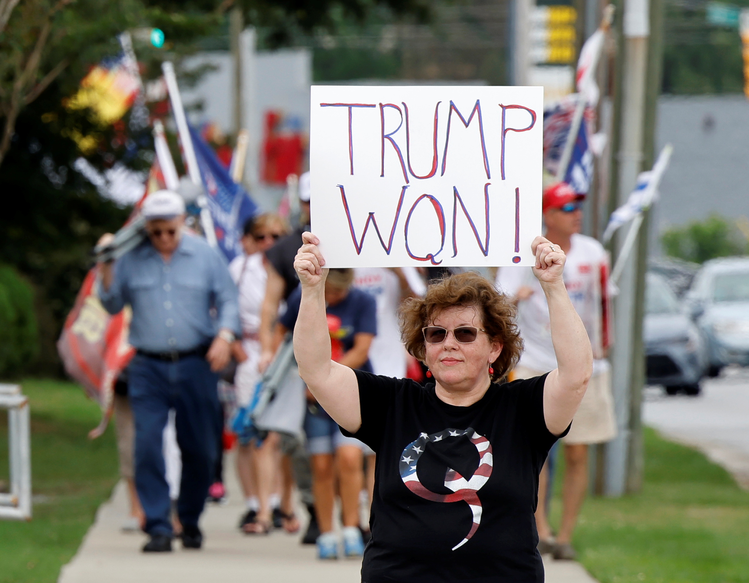 Supporter of former President Trump wears QAnon shirt outside the North Carolina GOP convention in Greenville