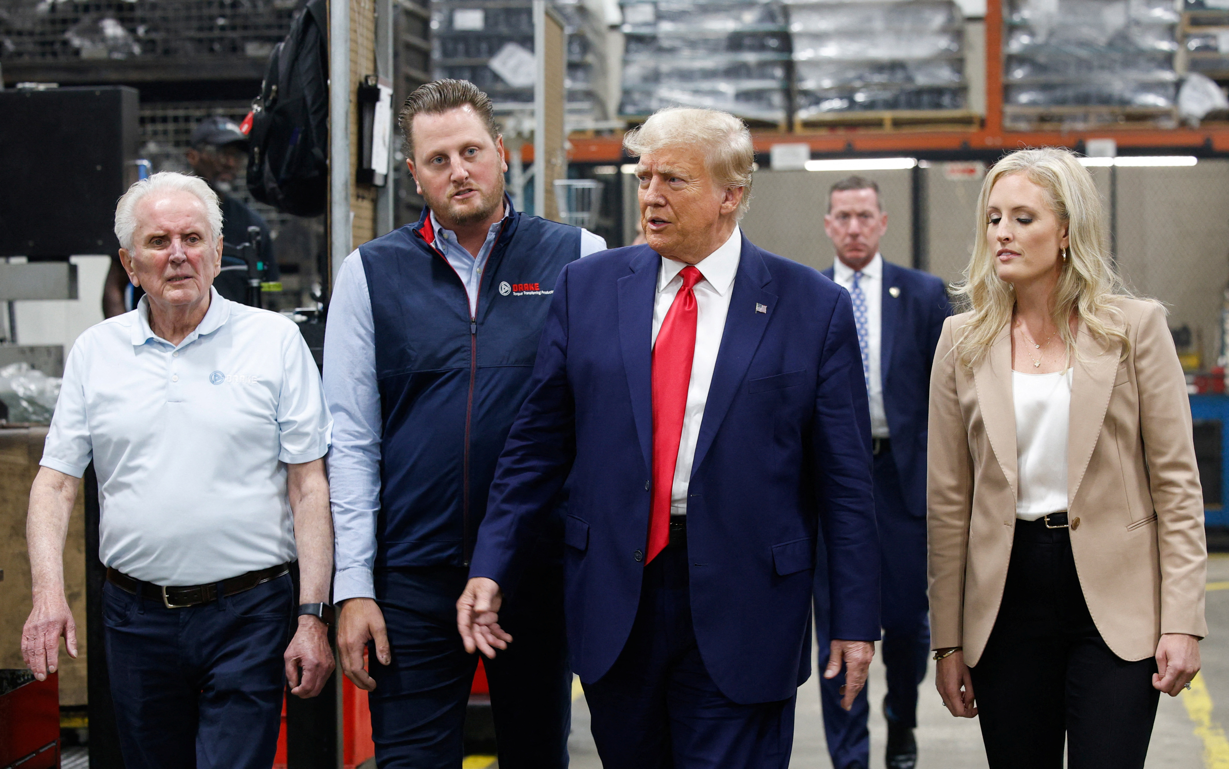 President Donald Trump visits and speaks with workers as he is