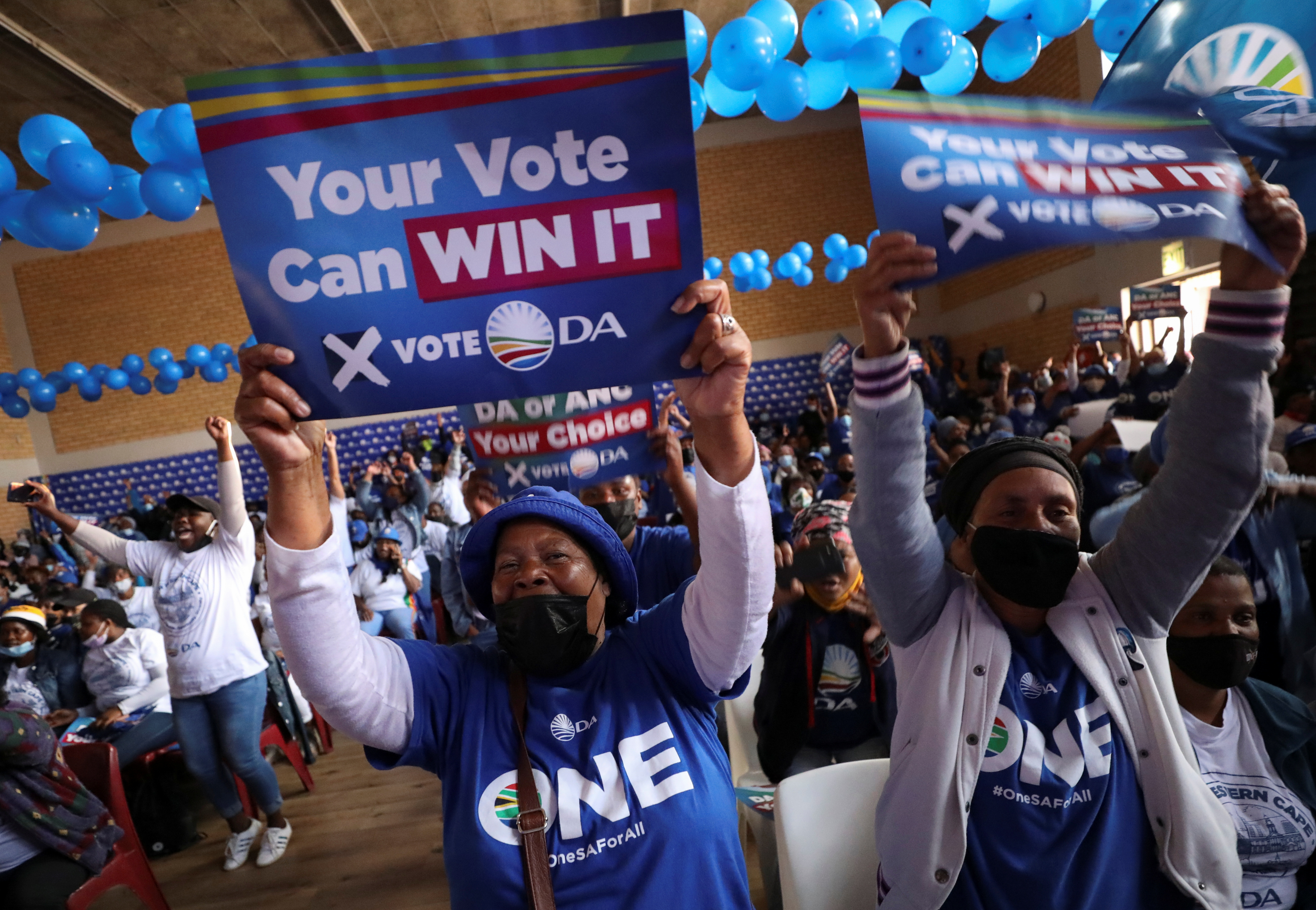 Supporters of the opposition Democratic Alliance (DA) party cheer at a rally ahead of the local government elections in Cape Town
