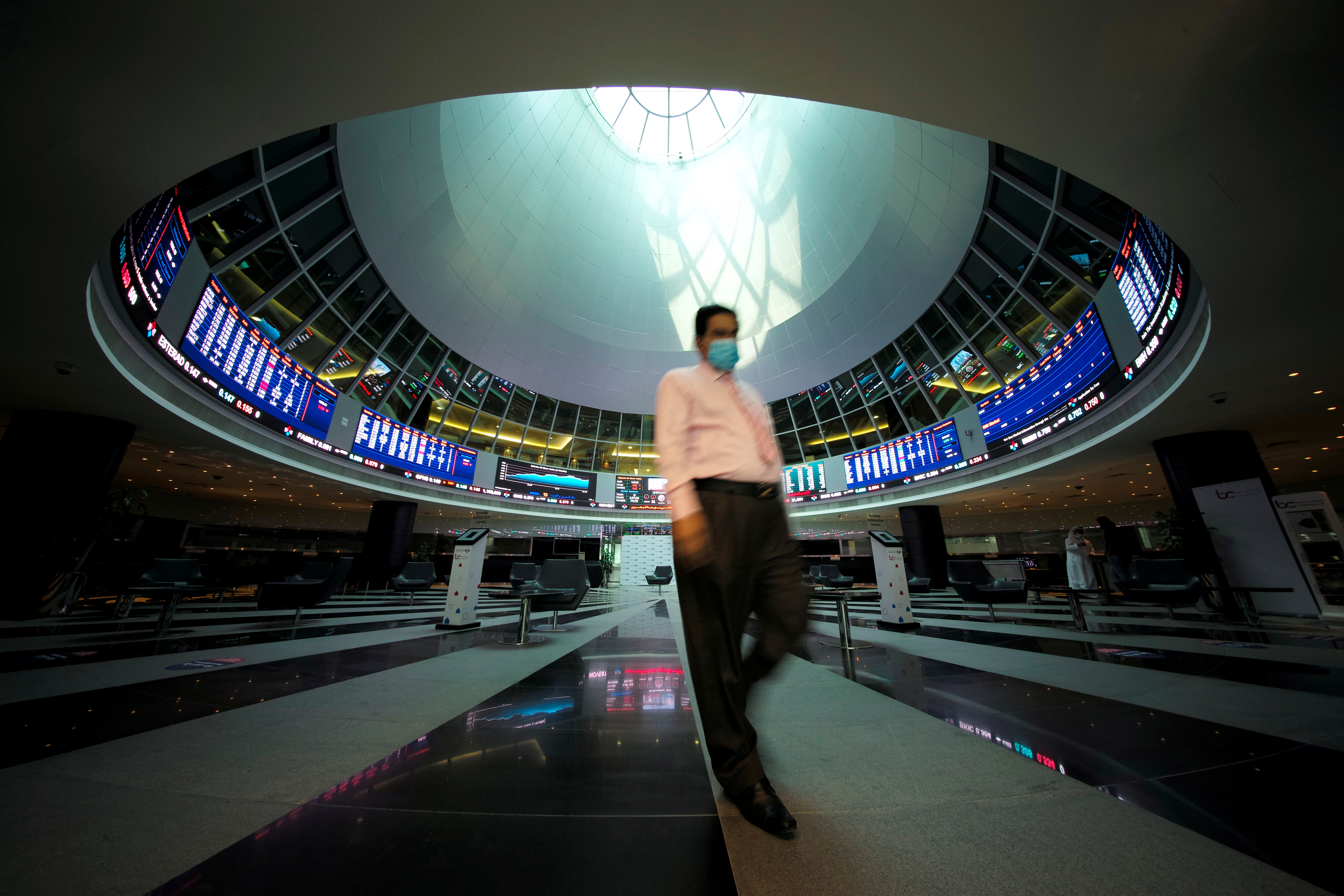 A trader walks out of Bahrain Bourse in Manama, Bahrain