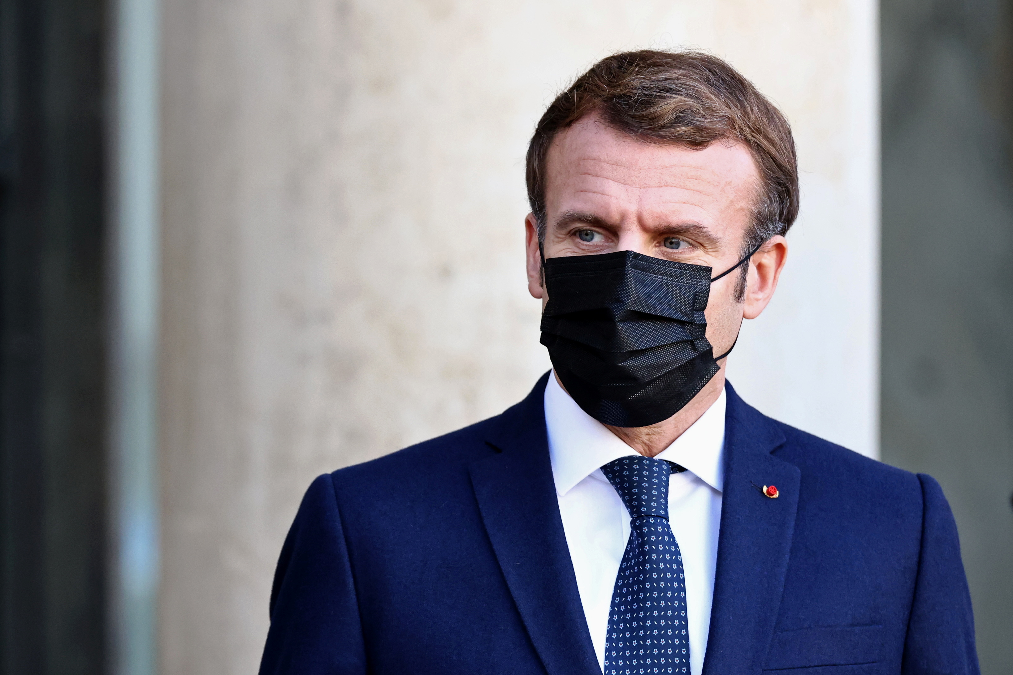 French President Emmanuel Macron, wearing a protective face mask, waits for a guest at the Elysee Palace in Paris, France, December 1, 2021. REUTERS/Sarah Meyssonnier
