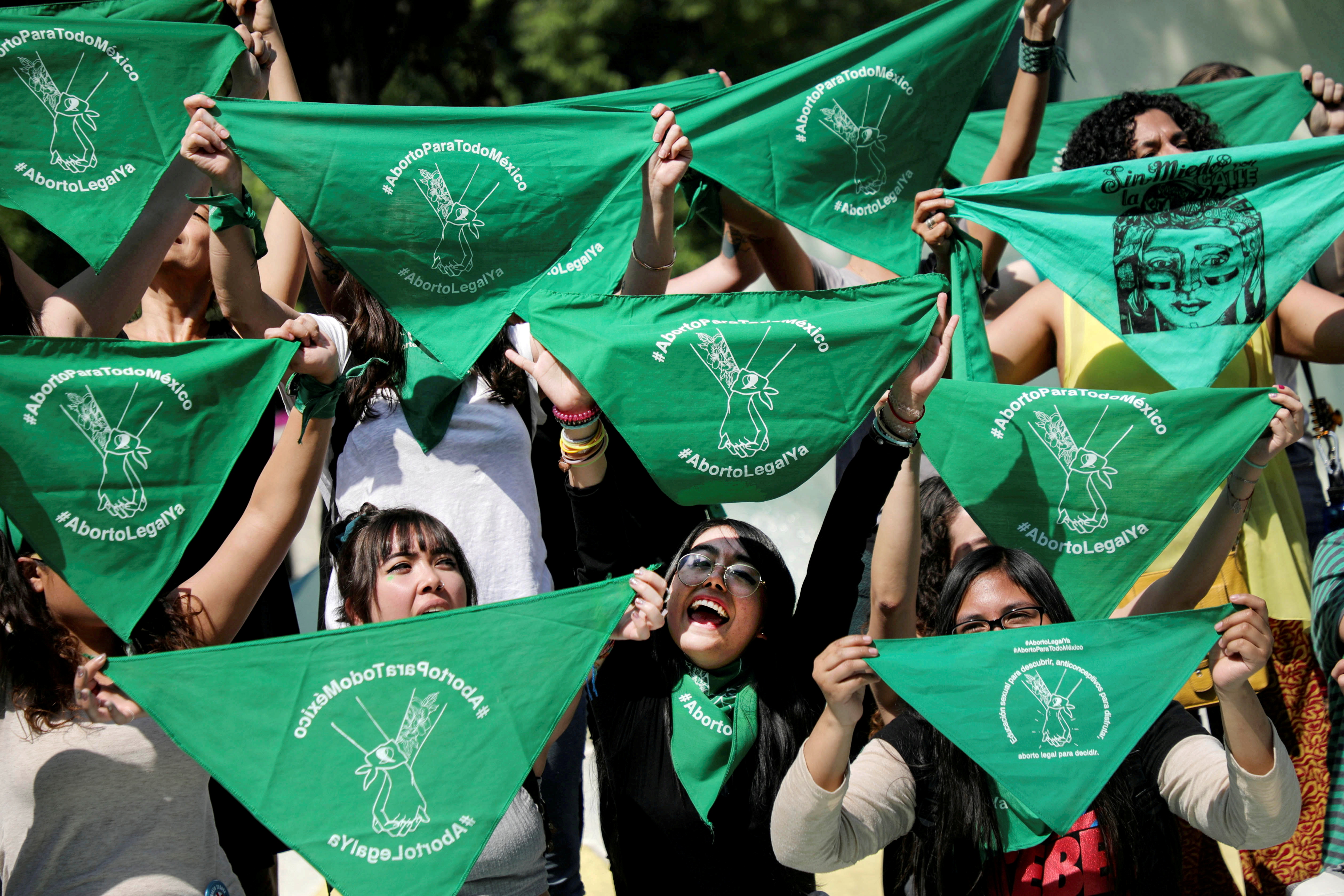 Women hold green handkerchiefs during a protest in support of legal and safe abortion in Mexico City