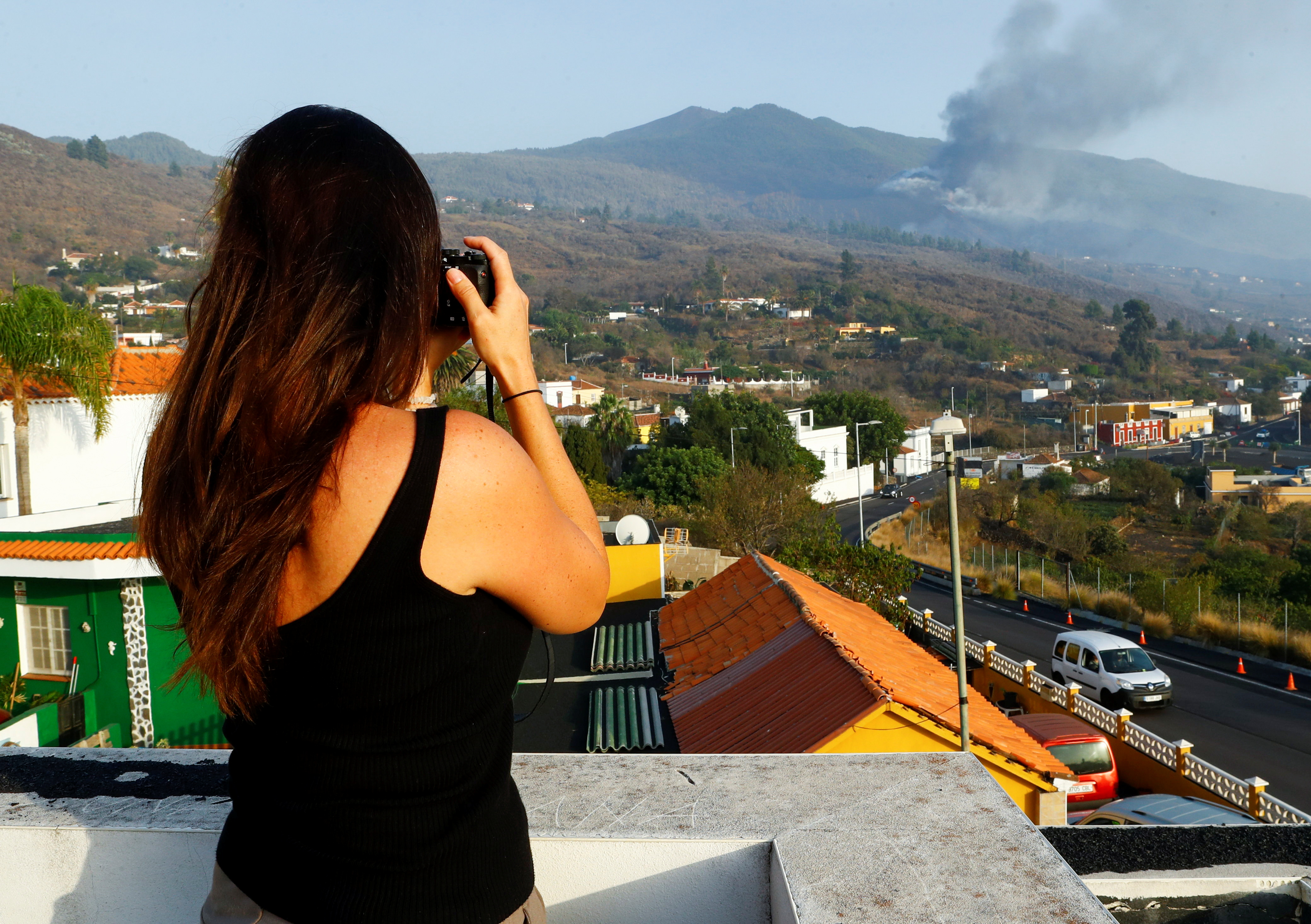 Czech Eva Kubelkova, a volcano fanatic based in the Azores, takes a picture of the Cumbre Vieja volcano, in El Paso