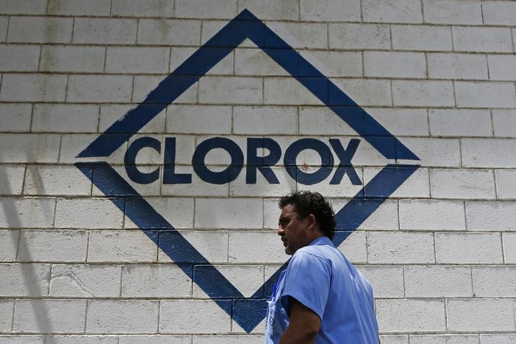 A Clorox worker walks past the's company logo at its headquarters in Valles del Tuy