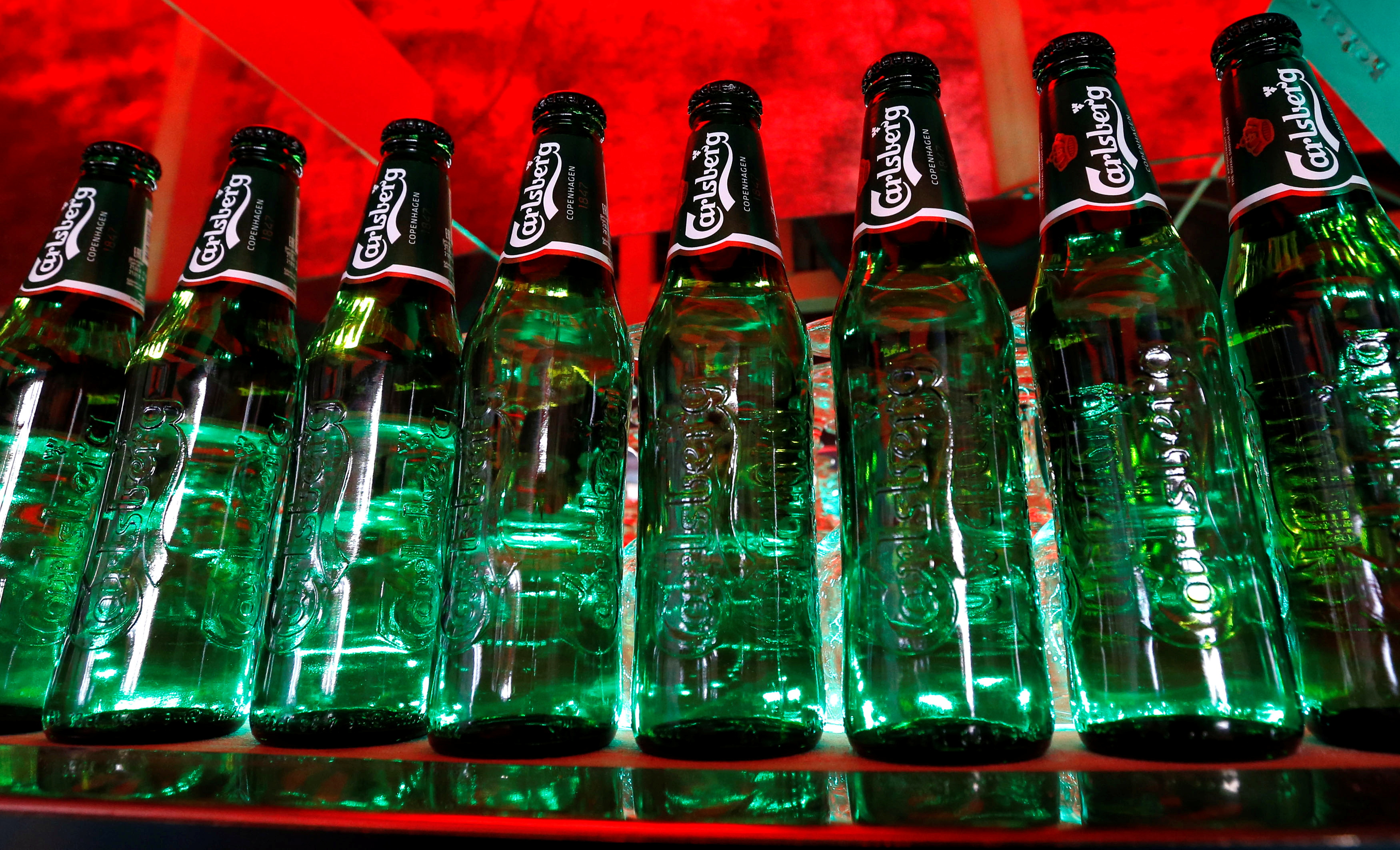 Bottles of Carlsberg beer are seen in a bar in St. Petersburg, Russia, June 17, 2014. REUTERS/Alexander Demianchuk/File Photo