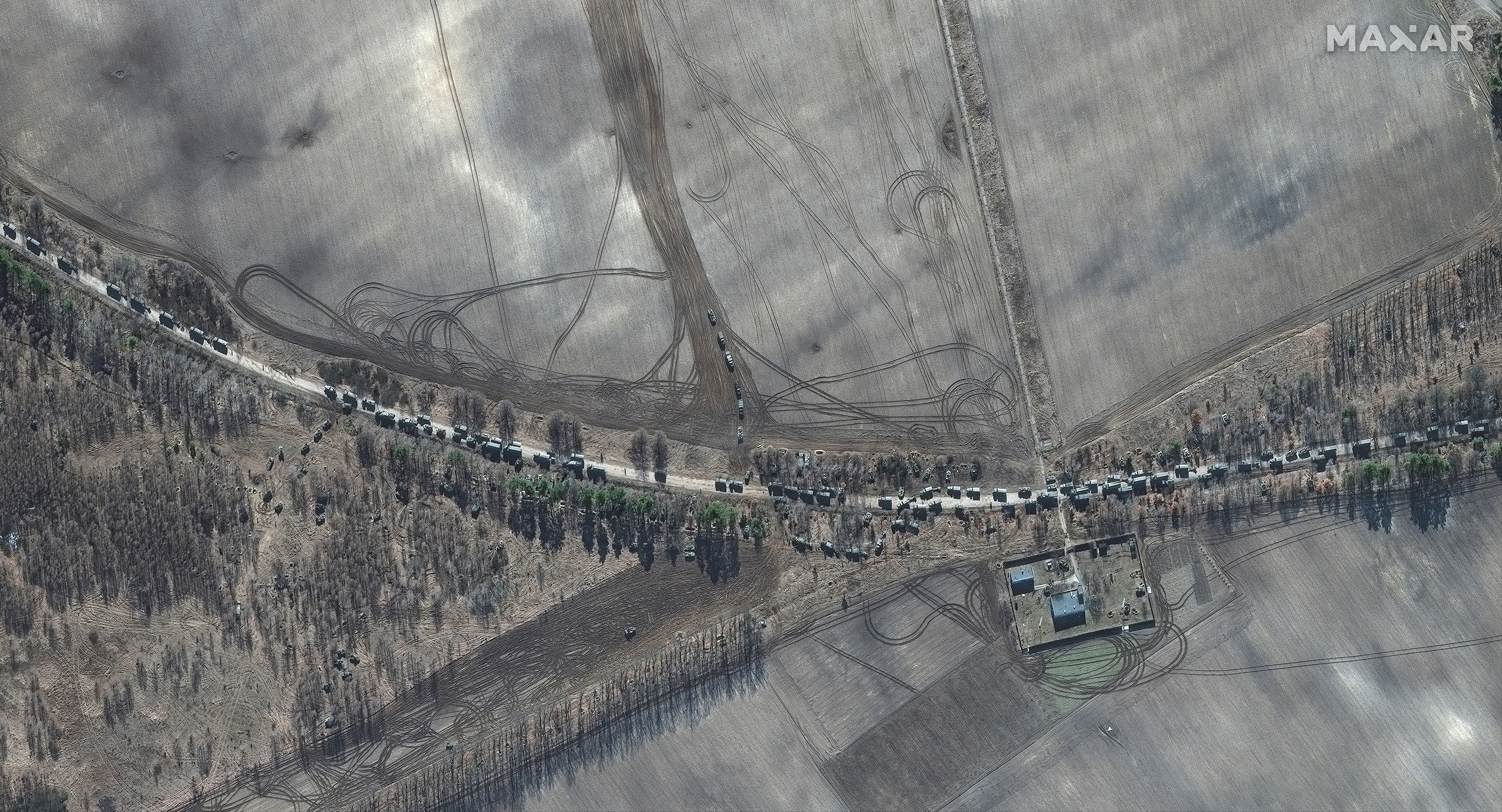 A satellite image shows southern end of convoy armour towed artillery trucks, east of Antonov airport