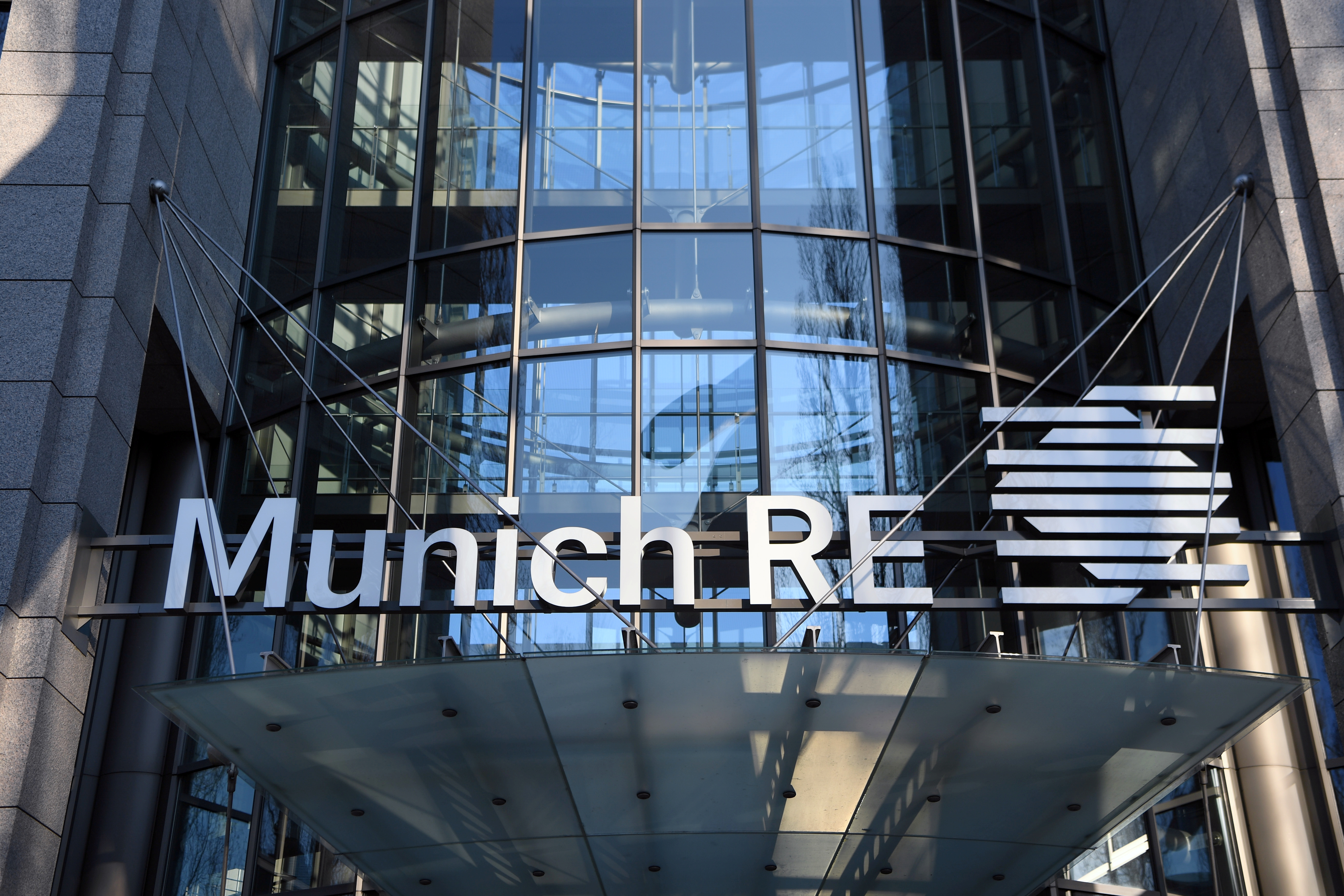 The logo of reinsurance company Munich Re Group is seen next to the entrance of their headquarters in Munich