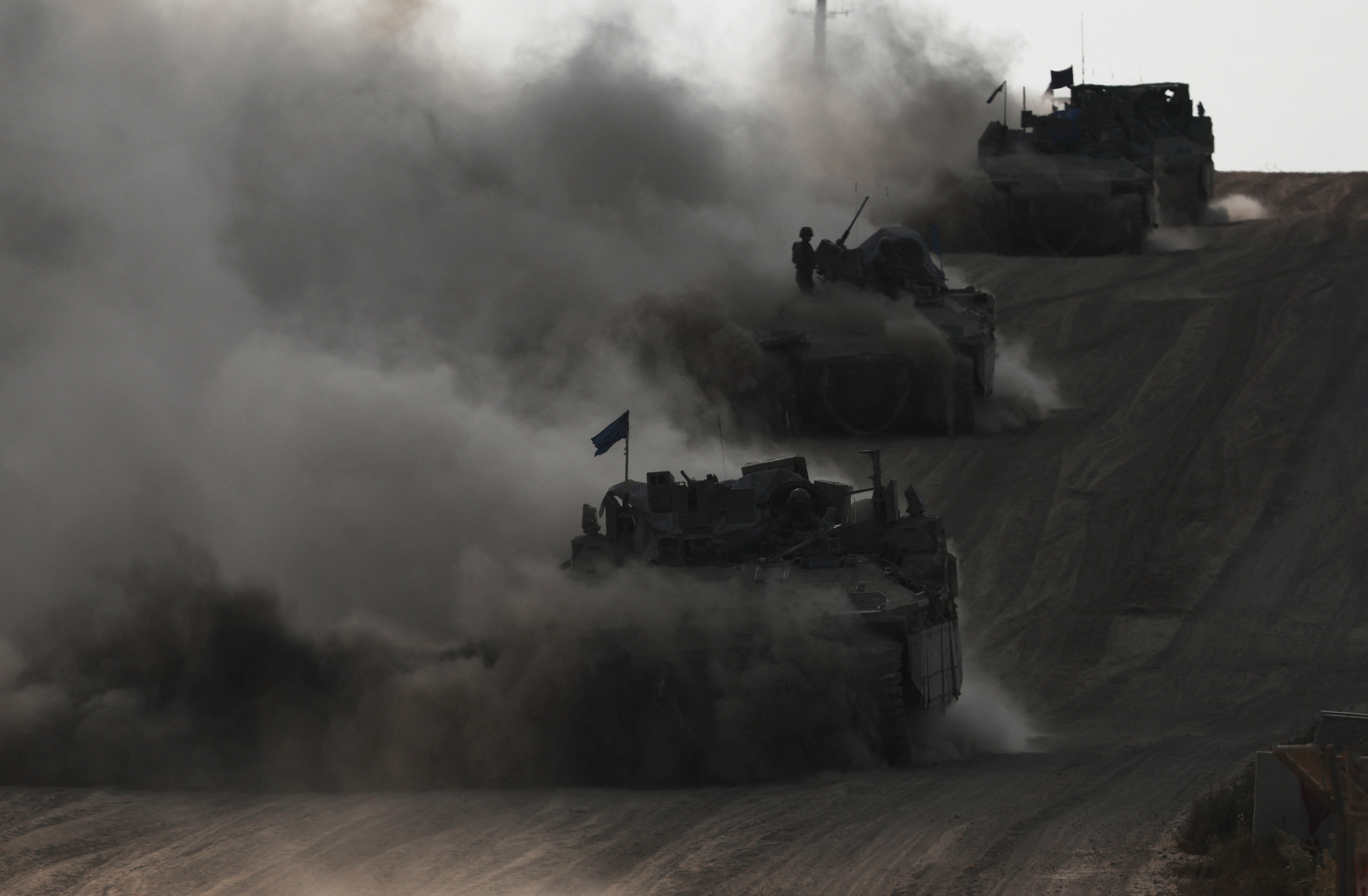 Israeli armoured personnel carriers (APC) operate, amid the ongoing conflict between Israel and the Palestinian Islamist group Hamas, near Israel's border with Gaza in southern Israel