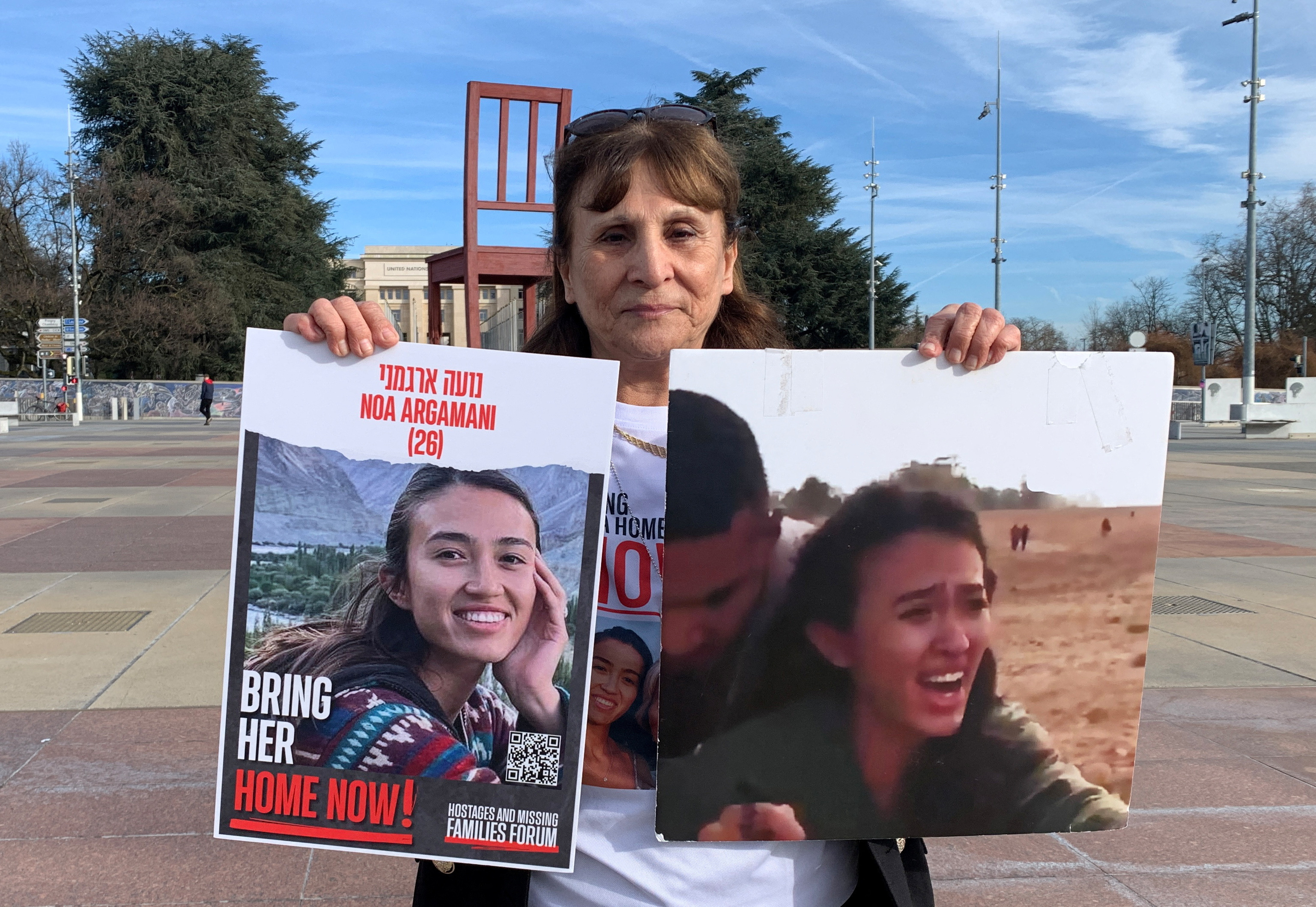 Ohad, aunt of Noa Argamani who was taken hostage by Hamas during the October 7 attack, poses with posters in Geneva