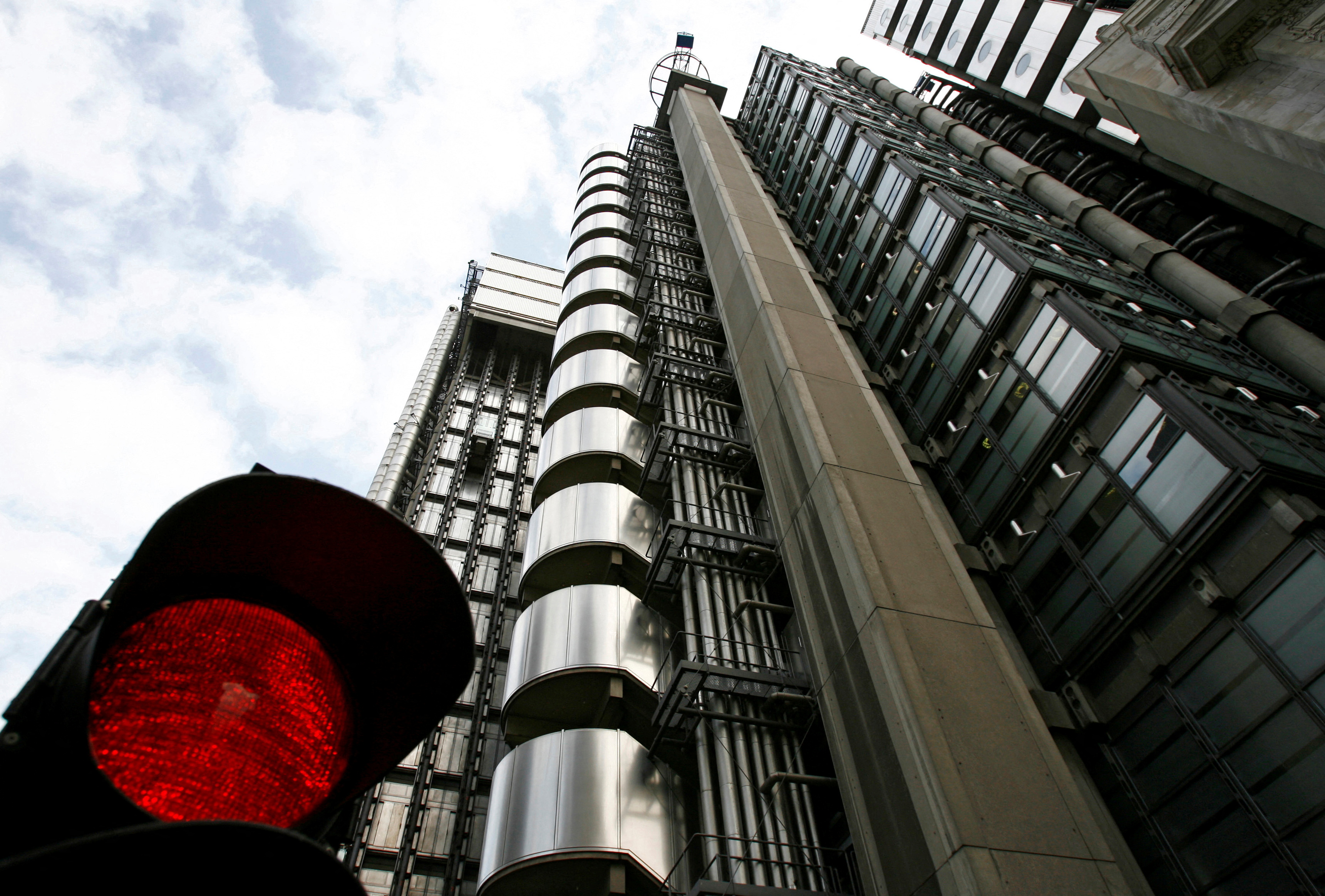 The Lloyds building is seen behind a temporary traffic signal in the city of London