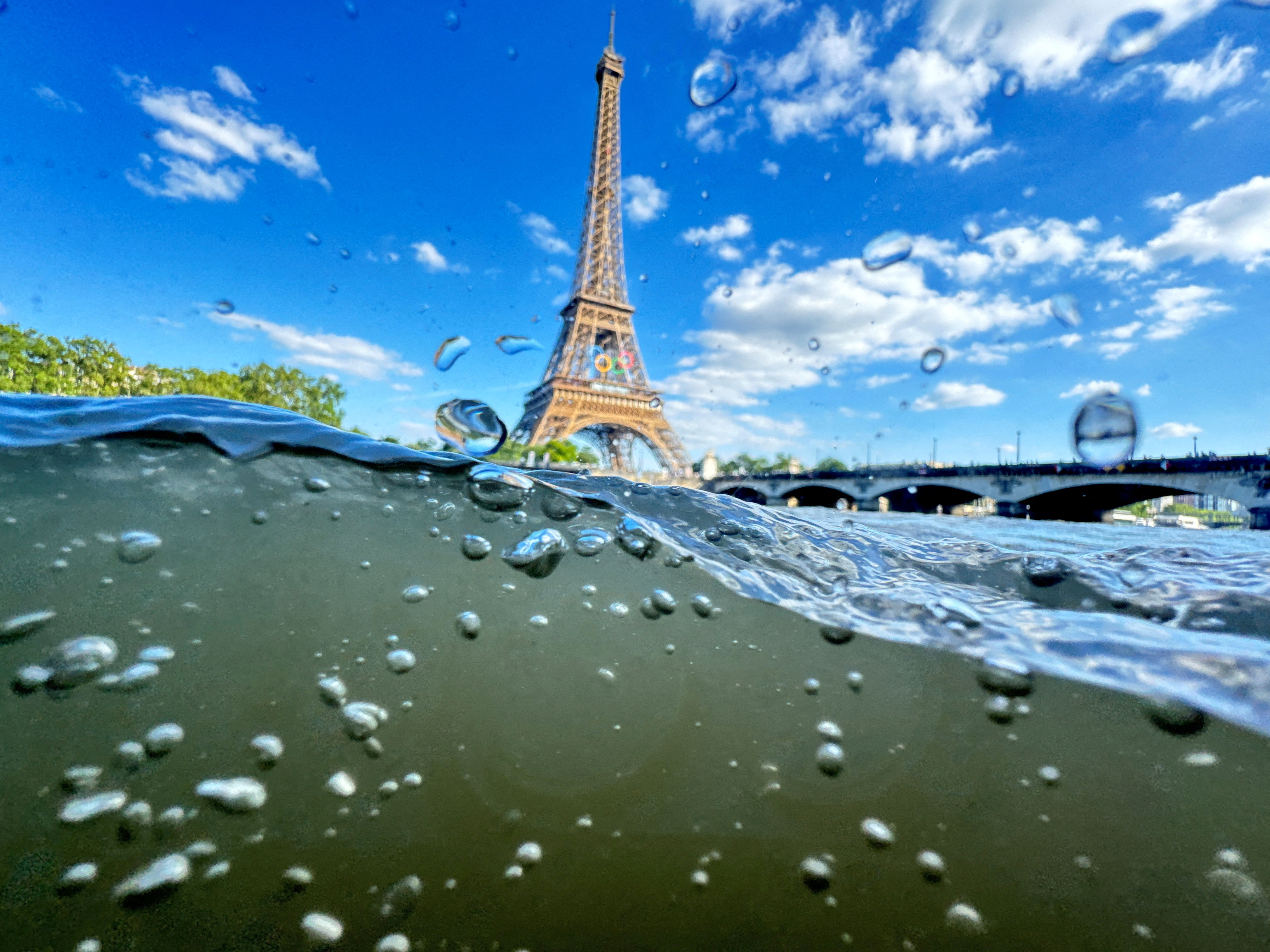 FILE PHOTO: The Eiffel Tower is seen from the water of the Seine River as the Olympics opening ceremony rehearsal is postponed amid rainy weather.