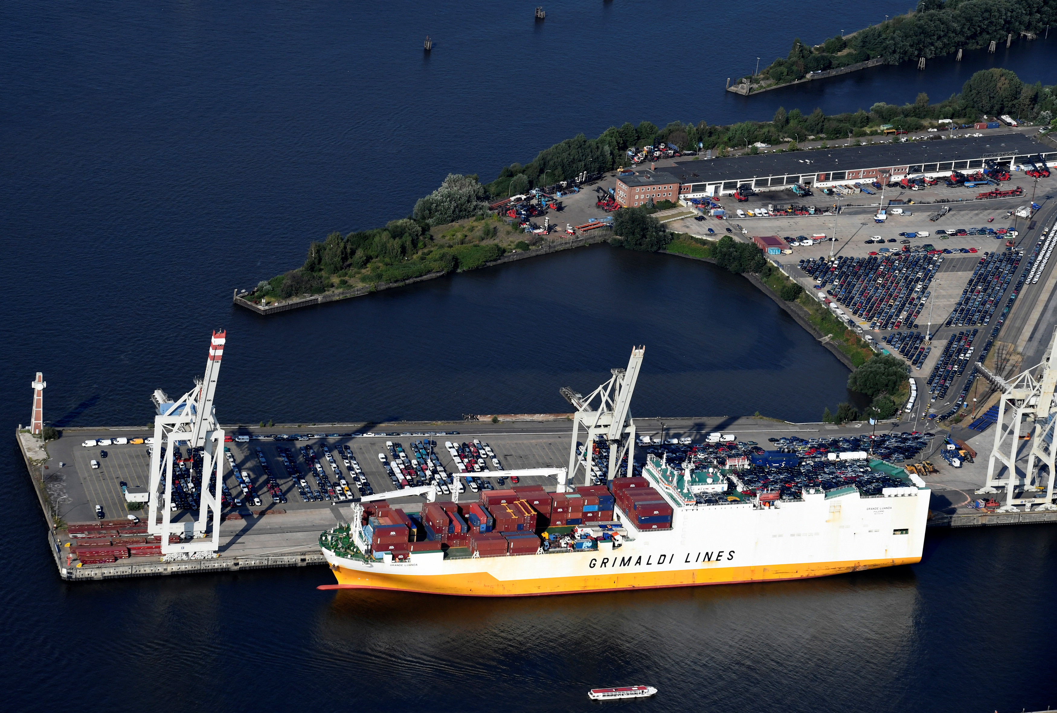 Export cars are loaded on a RoRo ship of Italian Grimaldi Group at a terminal in the port of Hamburg