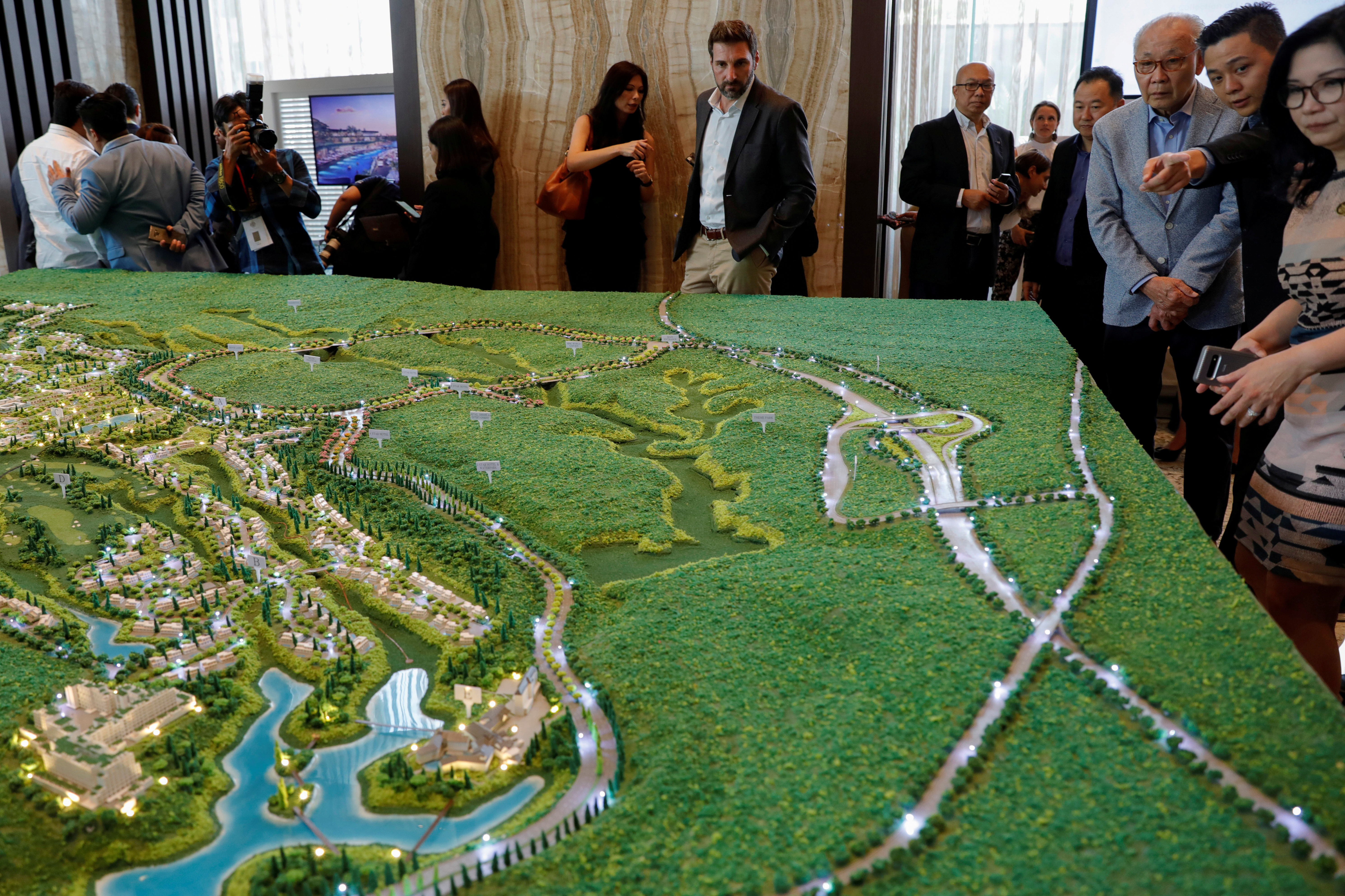 Visitors look at the models of Trump Residences Lido during the pre-launch of the Trump Residences, in Jakarta