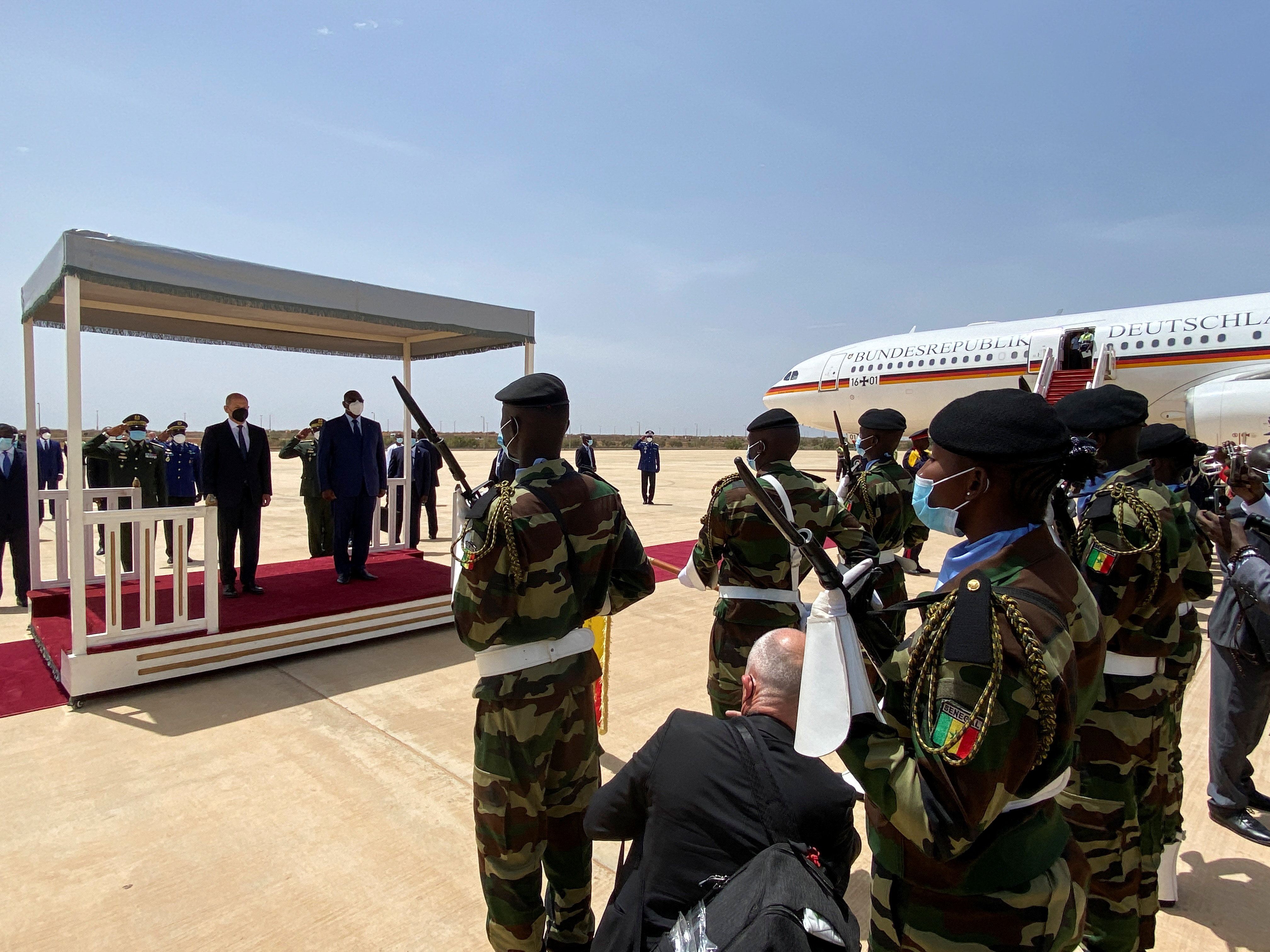 Senegal's President Sall welcomes German Chancellor Scholz upon his arrival, in Dakar