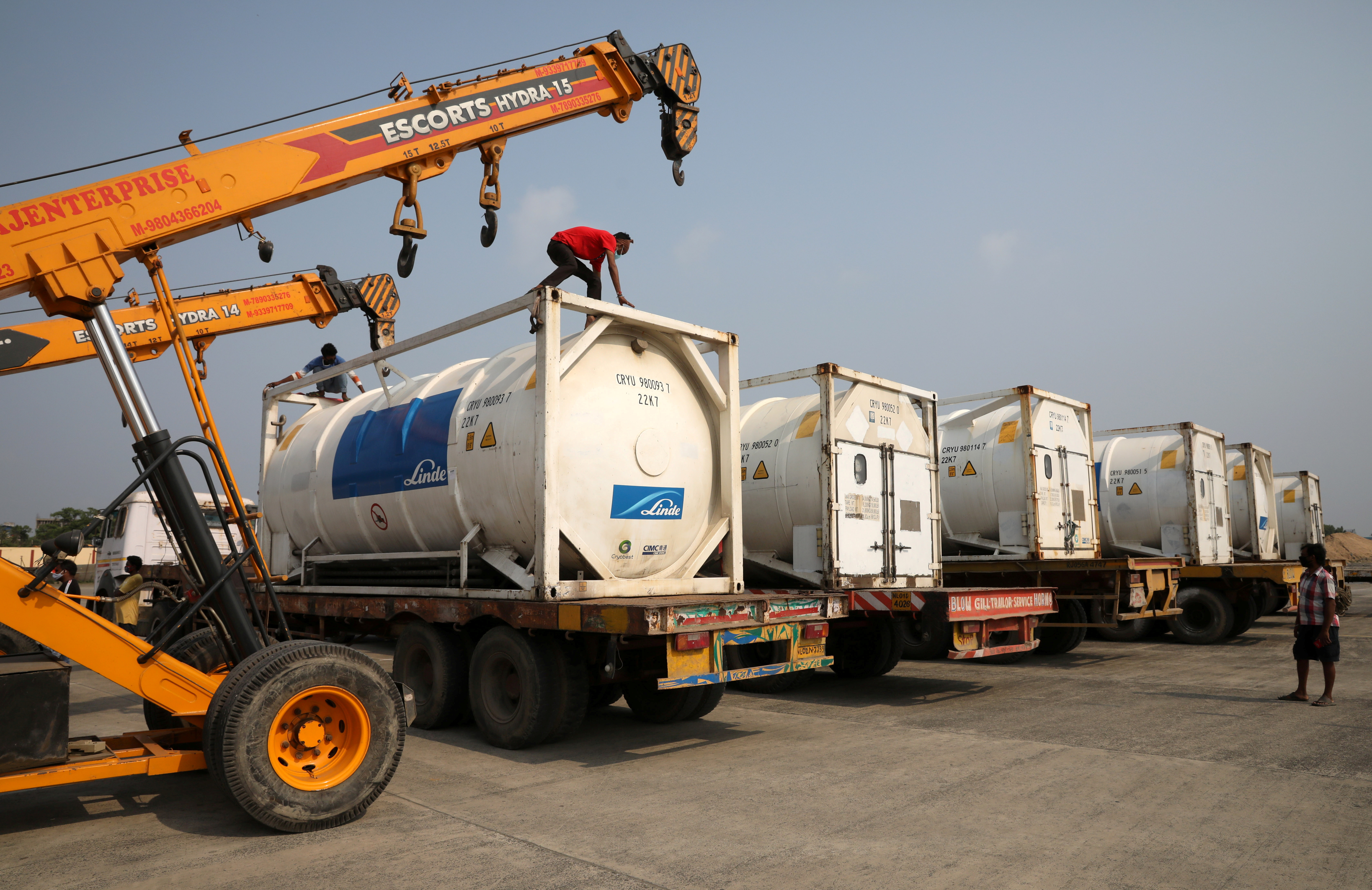 Men park Linde tankers after they arrived from abroad to help with coronavirus disease (COVID-19) crisis, in Kolkata