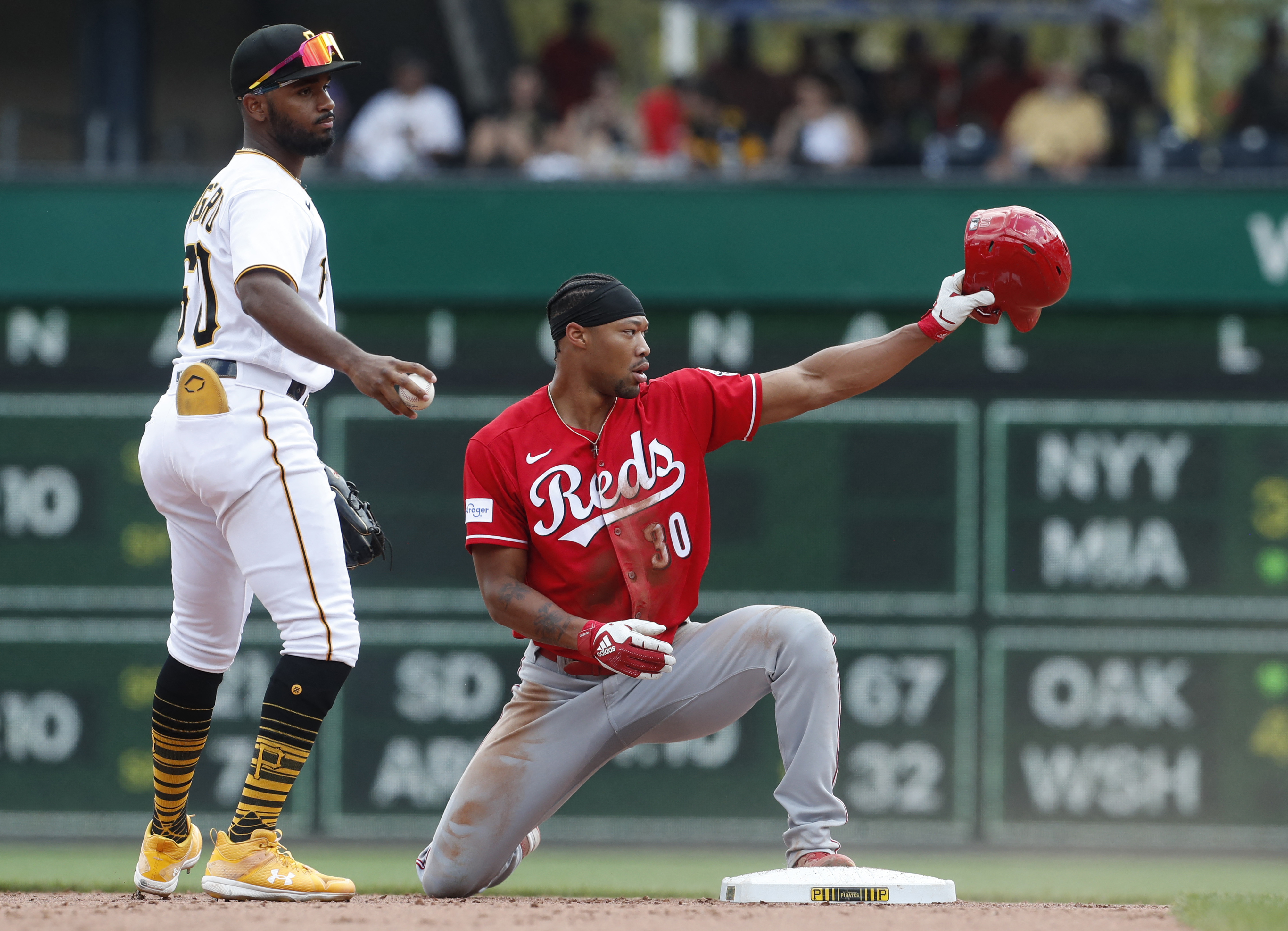 A Pittsburgh Pirates fans waves a Jolly Roger flag and holds a broom to  celebrate the Pirates' sweeping of a four-game series against the  Cincinnati Reds in a baseball game in Pittsburgh