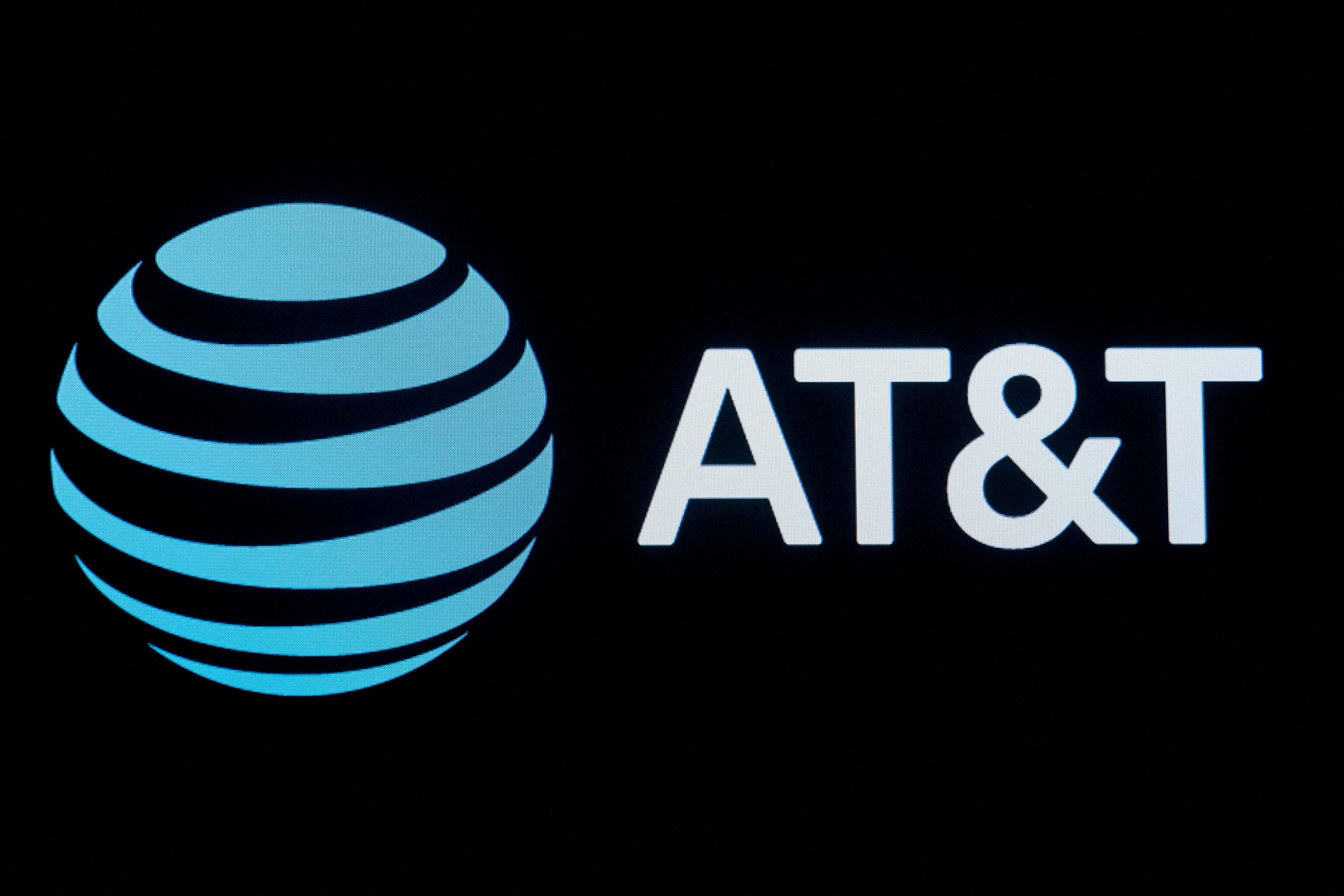 The company logo for AT&T is displayed on a screen on the floor at the NYSE in New York