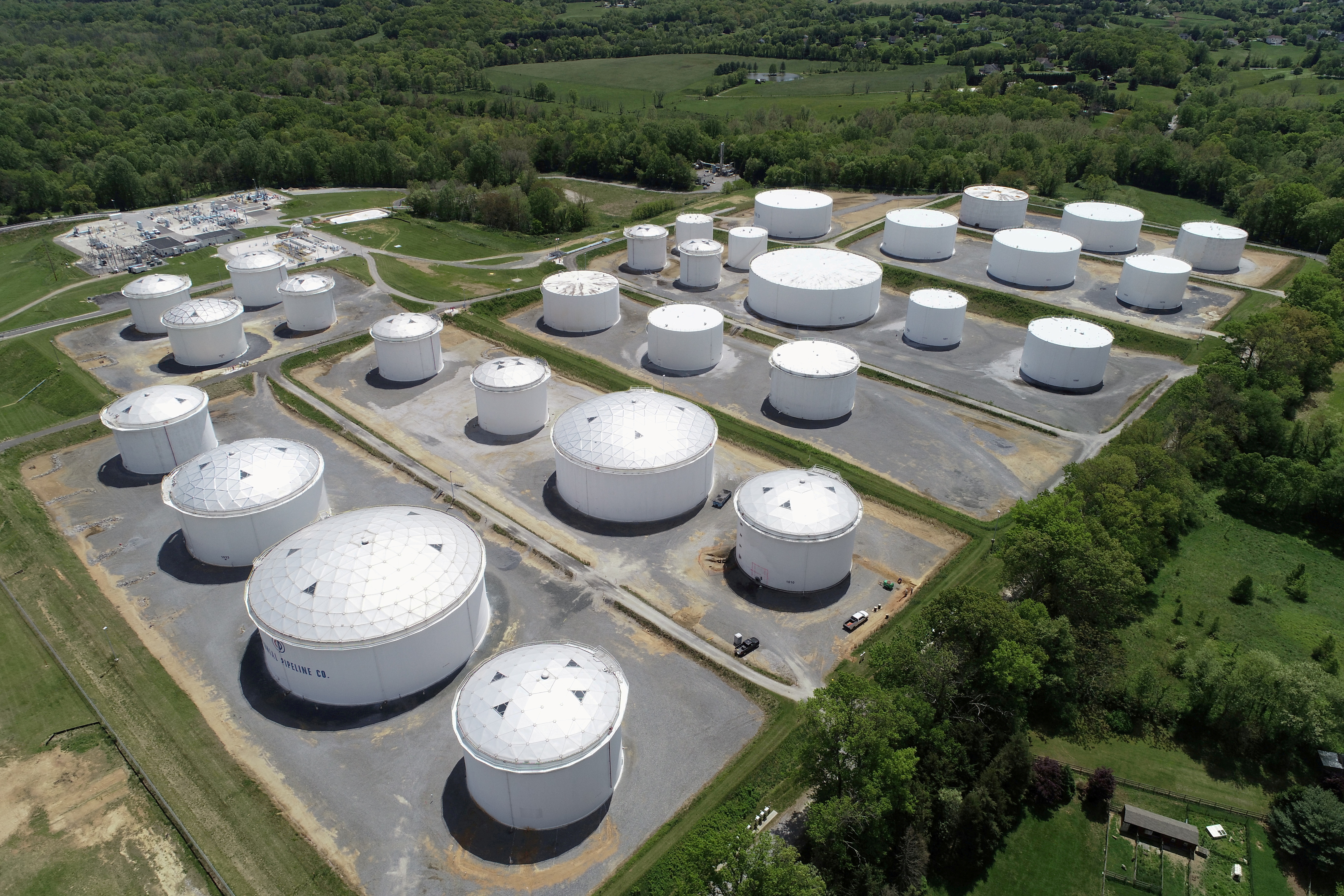 Holding tanks are seen in an aerial photograph at Colonial Pipeline's Dorsey Junction Station in Woodbine, Maryland, U.S. May 10, 2021. REUTERS/Drone Base/File Photo