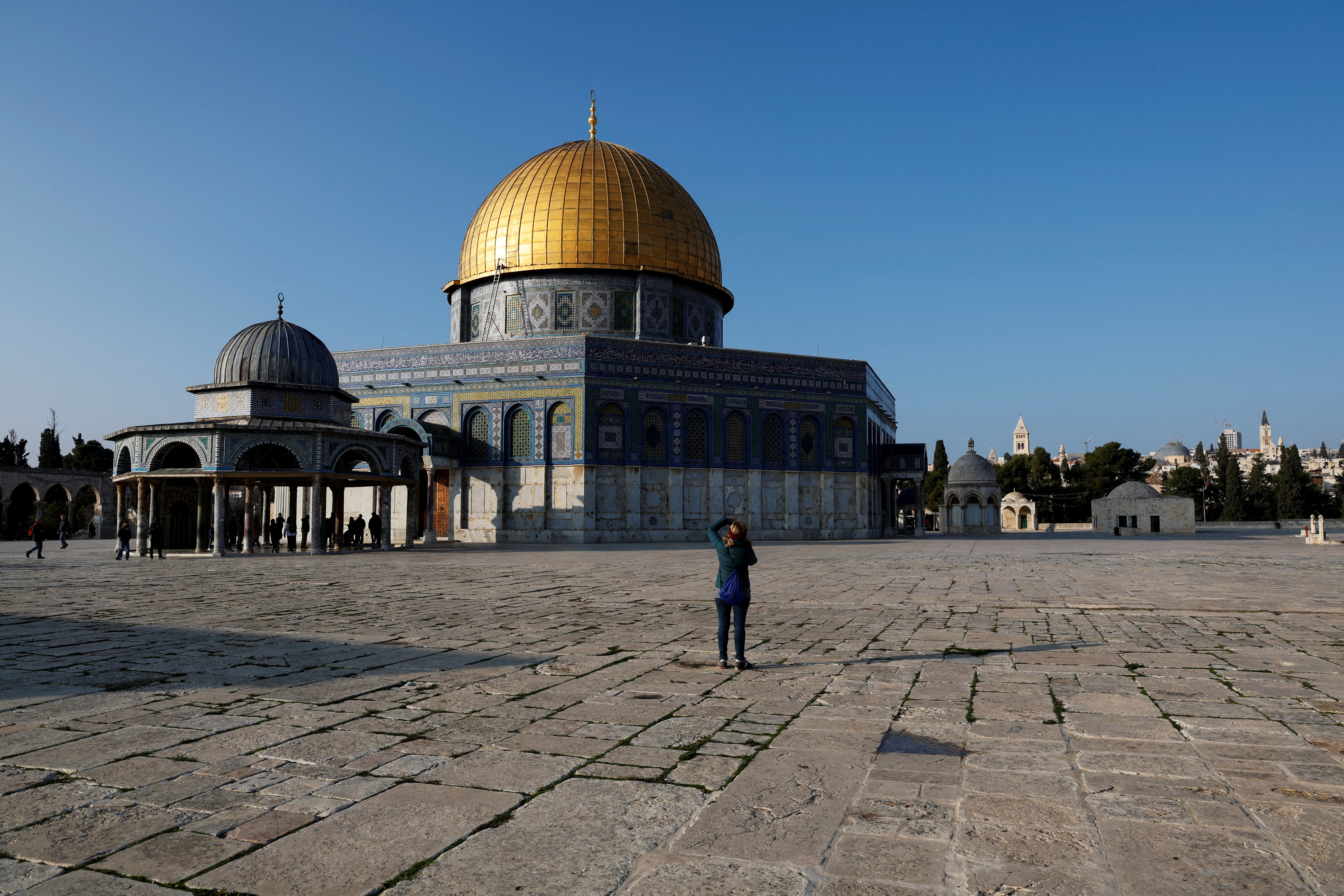 A visitor takes a picture next to the Dome of the Rock on the compound known to Muslims as the Noble Sanctuary and to Jews as the Temple Mount, in Jerusalem's Old City