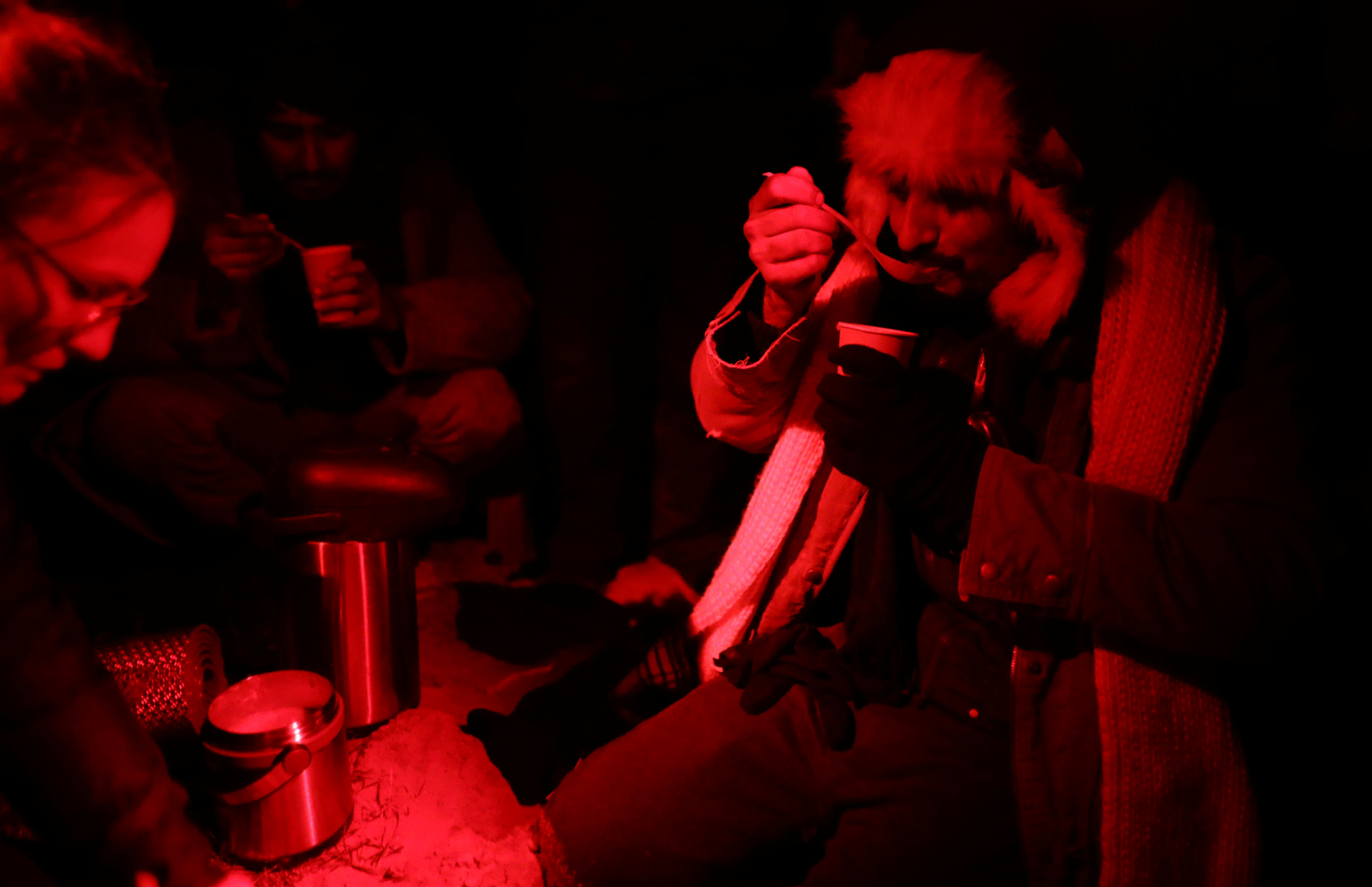 Migrant eats food provided by Ocalenie foundation after he crossed Belarusian-Polish border in the woods near Sokolka