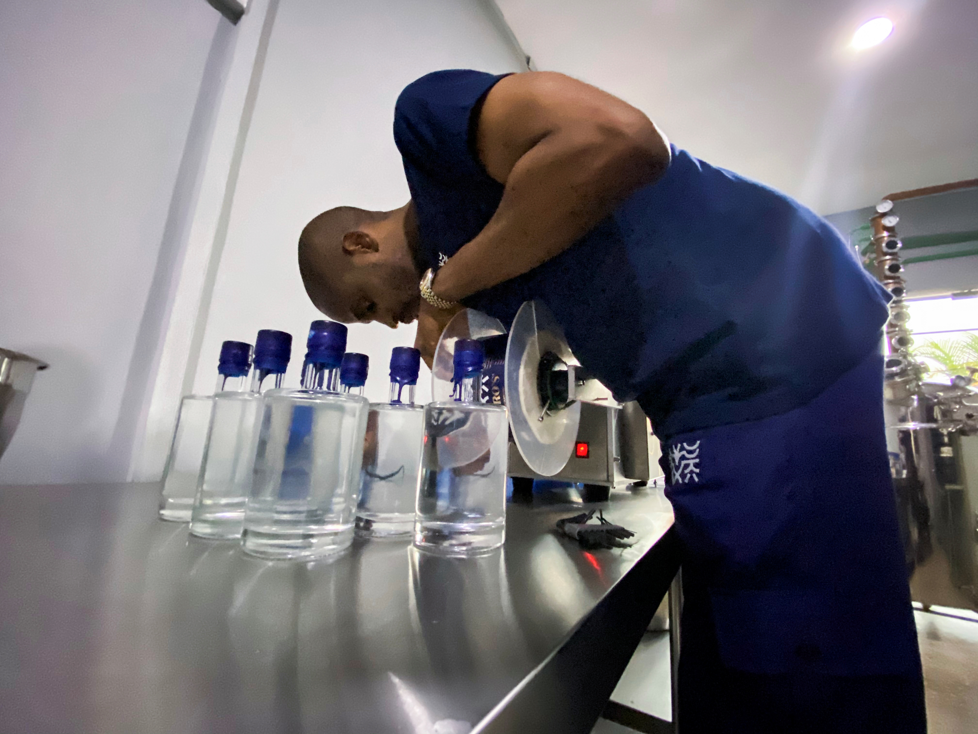 Chibueze Akukwe, co-founder of Pedro's gin distillery is seen fixing a tool during a production in Lagos