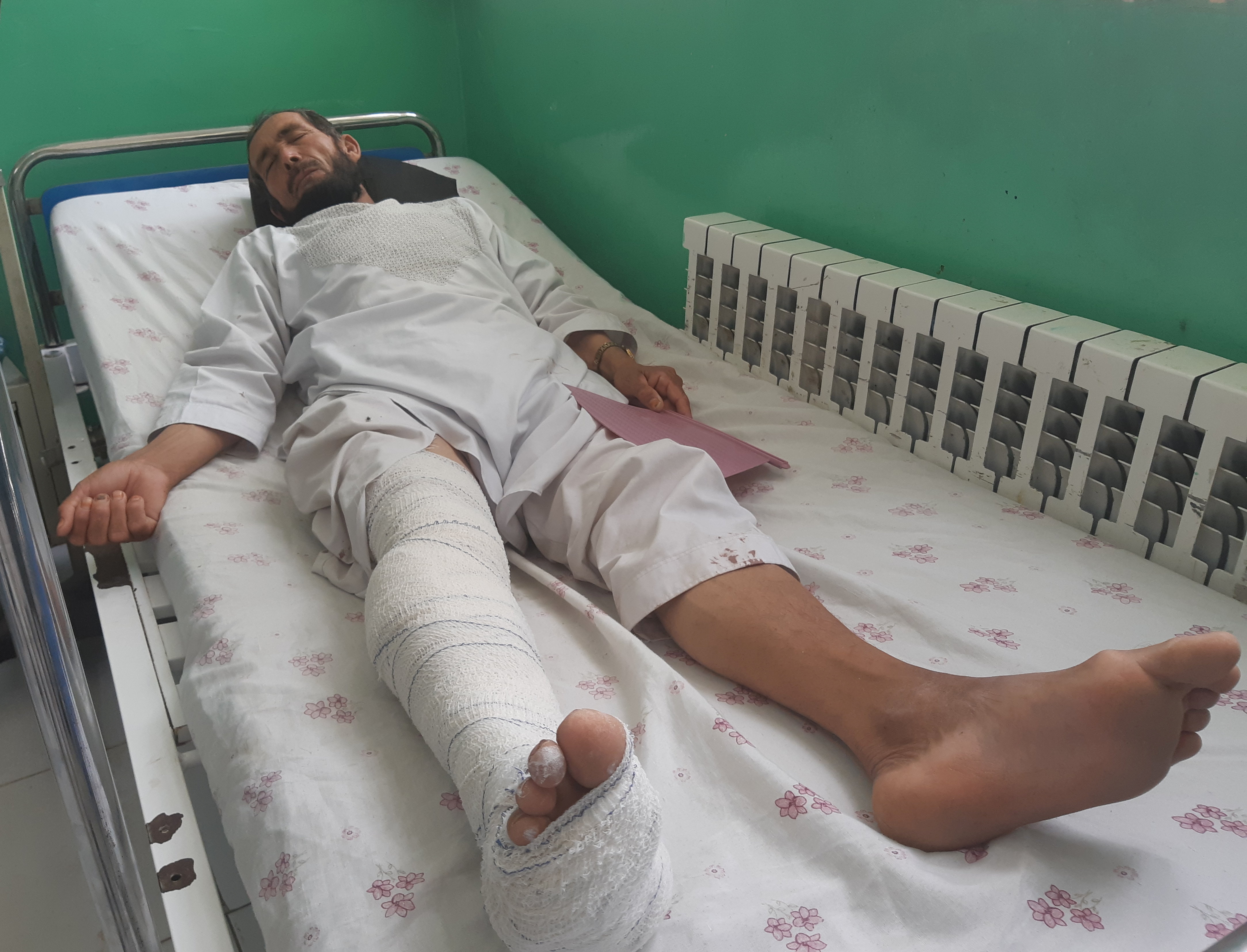Wounded worker from a de-mining organisation receives treatment at a hospital in Baghlan province
