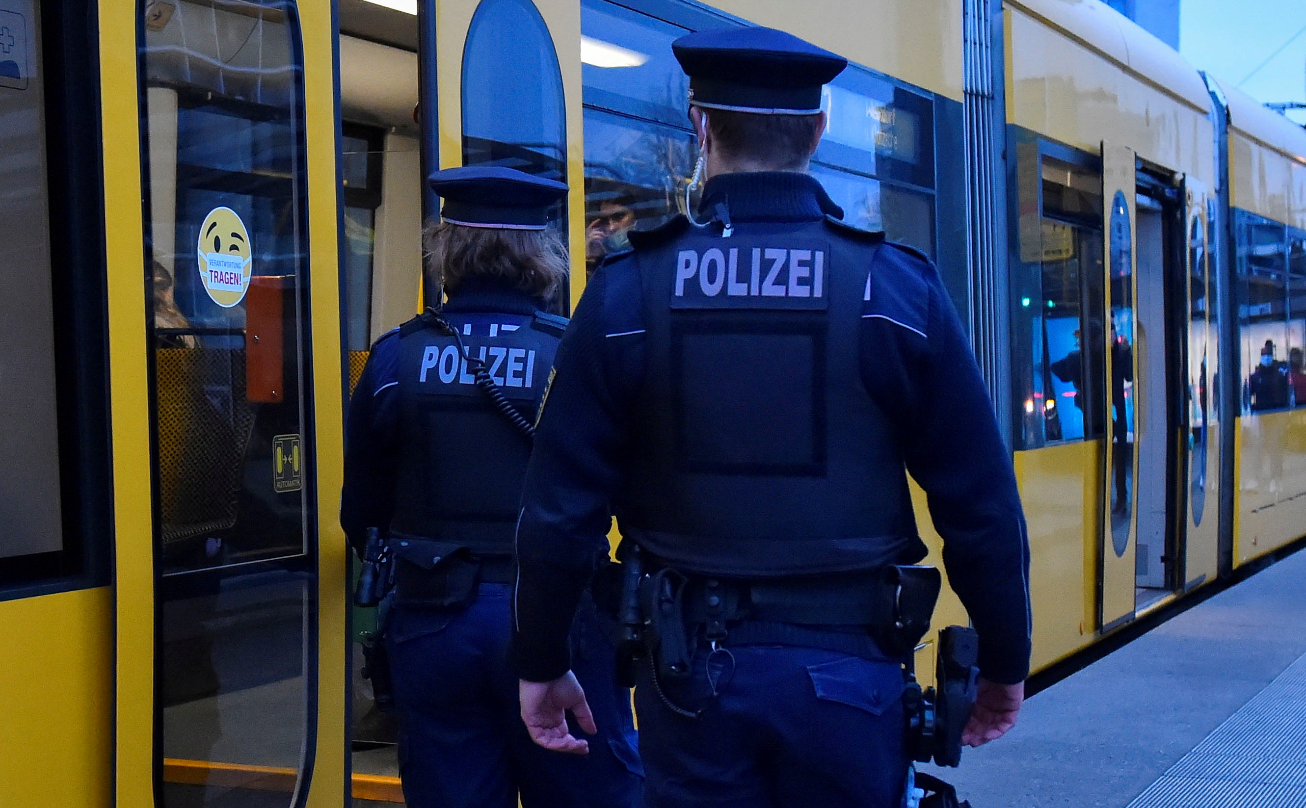 Police officers enter a tram as they check the coronavirus disease (COVID-19) protocol in Dresden, Germany, November 23, 2021. REUTERS/Matthias Rietschel