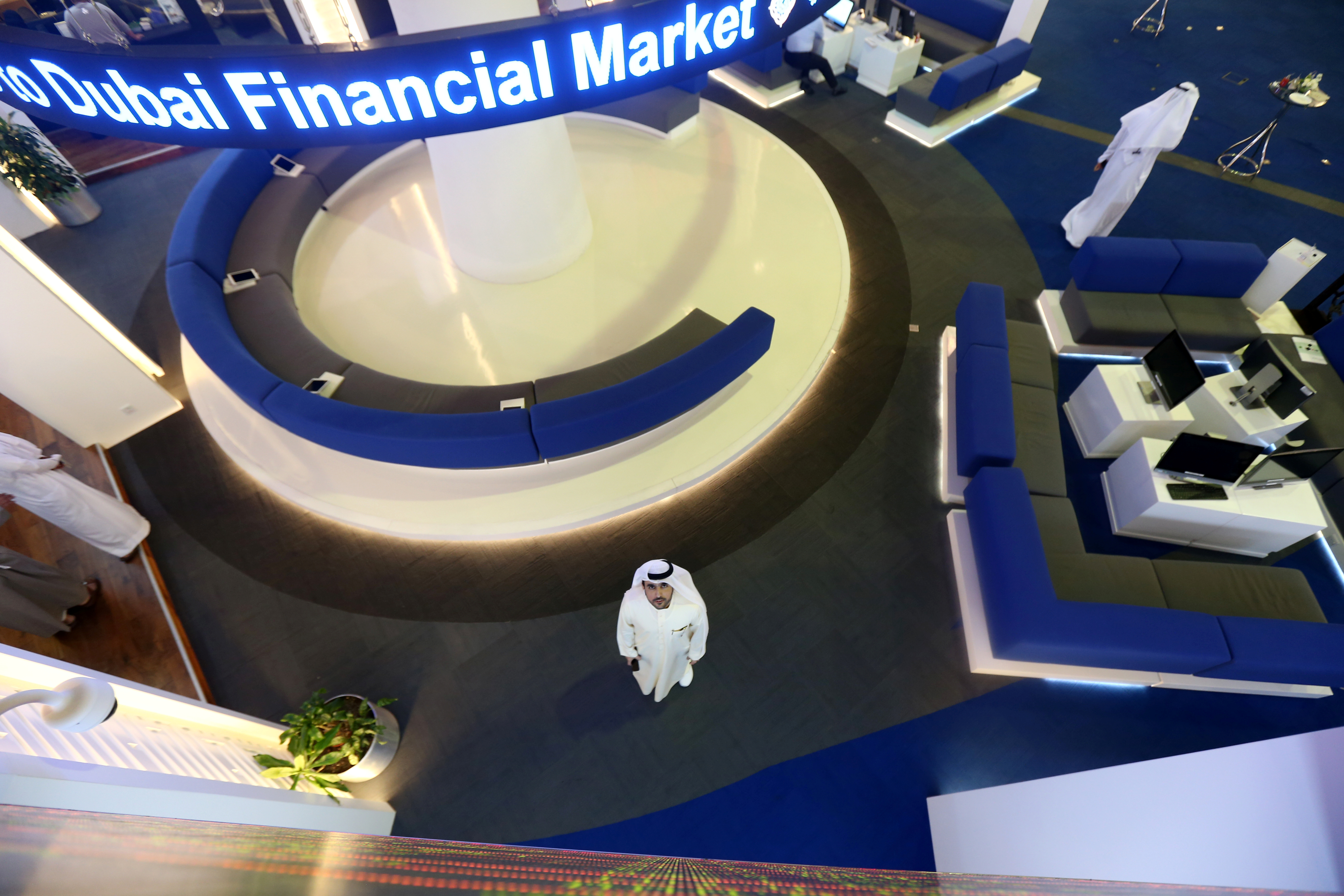 Investor looks at the screen at the Dubai International Financial Market in Dubai
