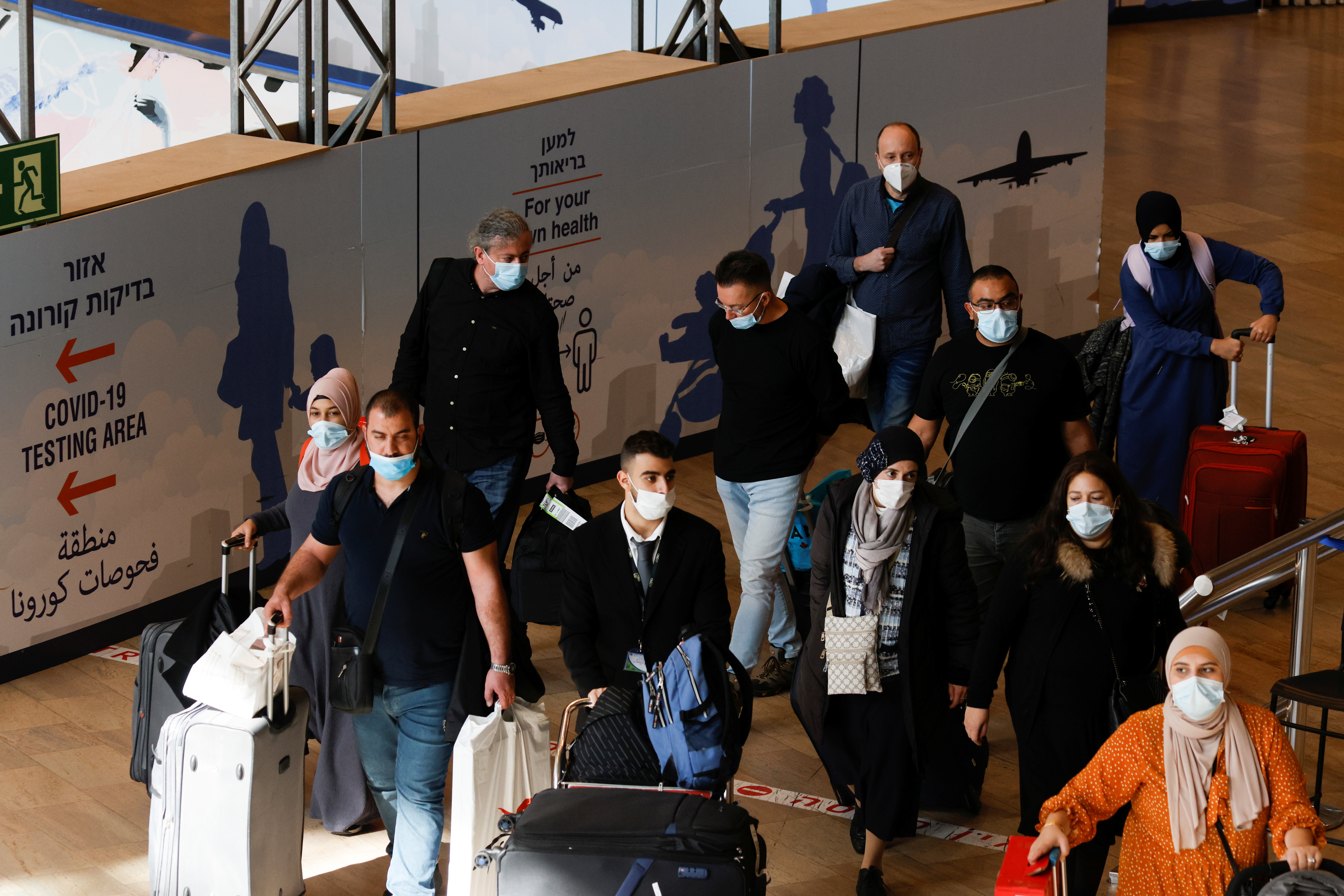 Travellers walk towards the coronavirus disease (COVID-19) pandemic testing area at Ben Gurion International Airport