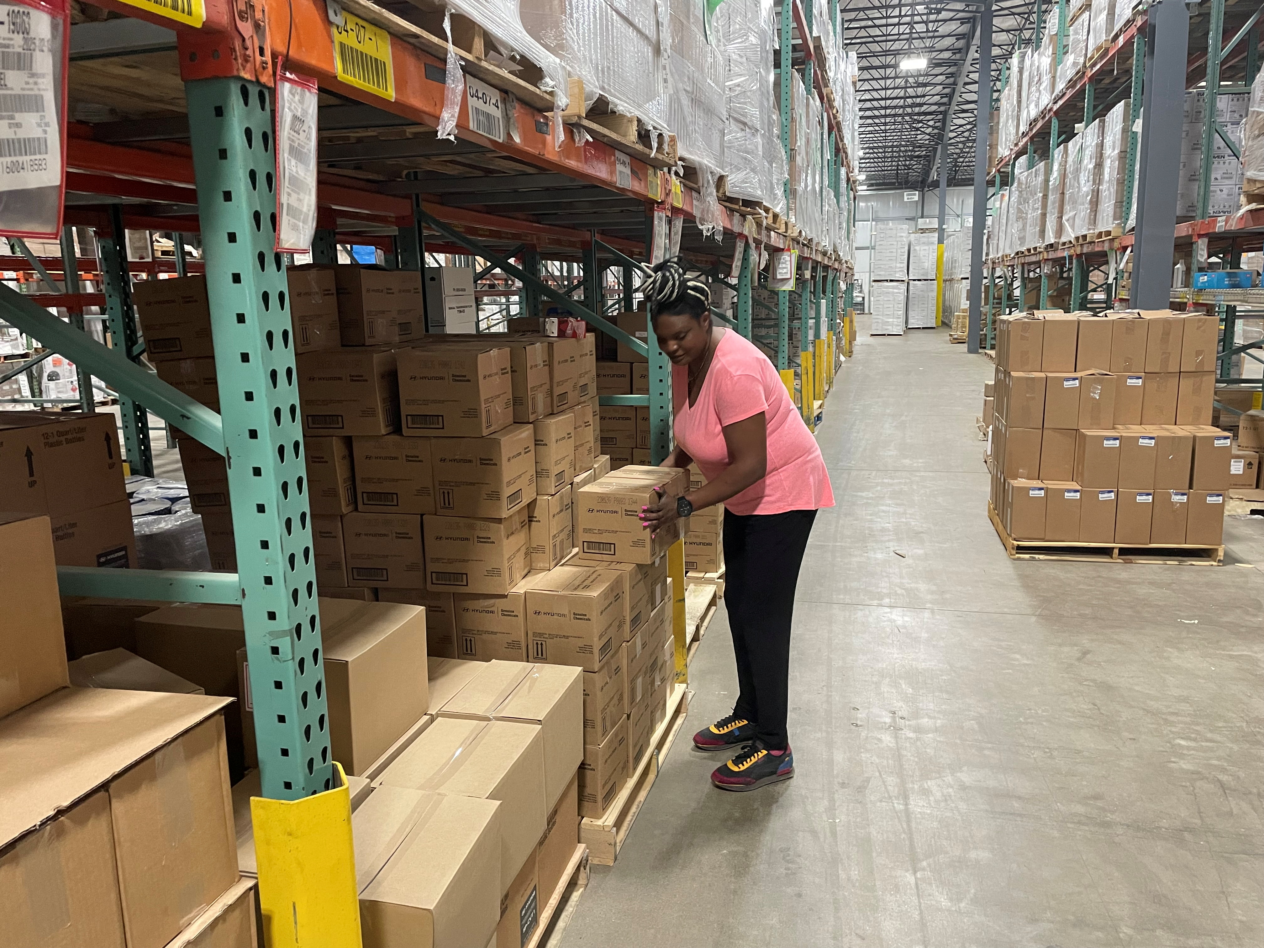 Sheila Ikenye picks boxes for a shipment at Kem Krest's warehouse in Elkhart