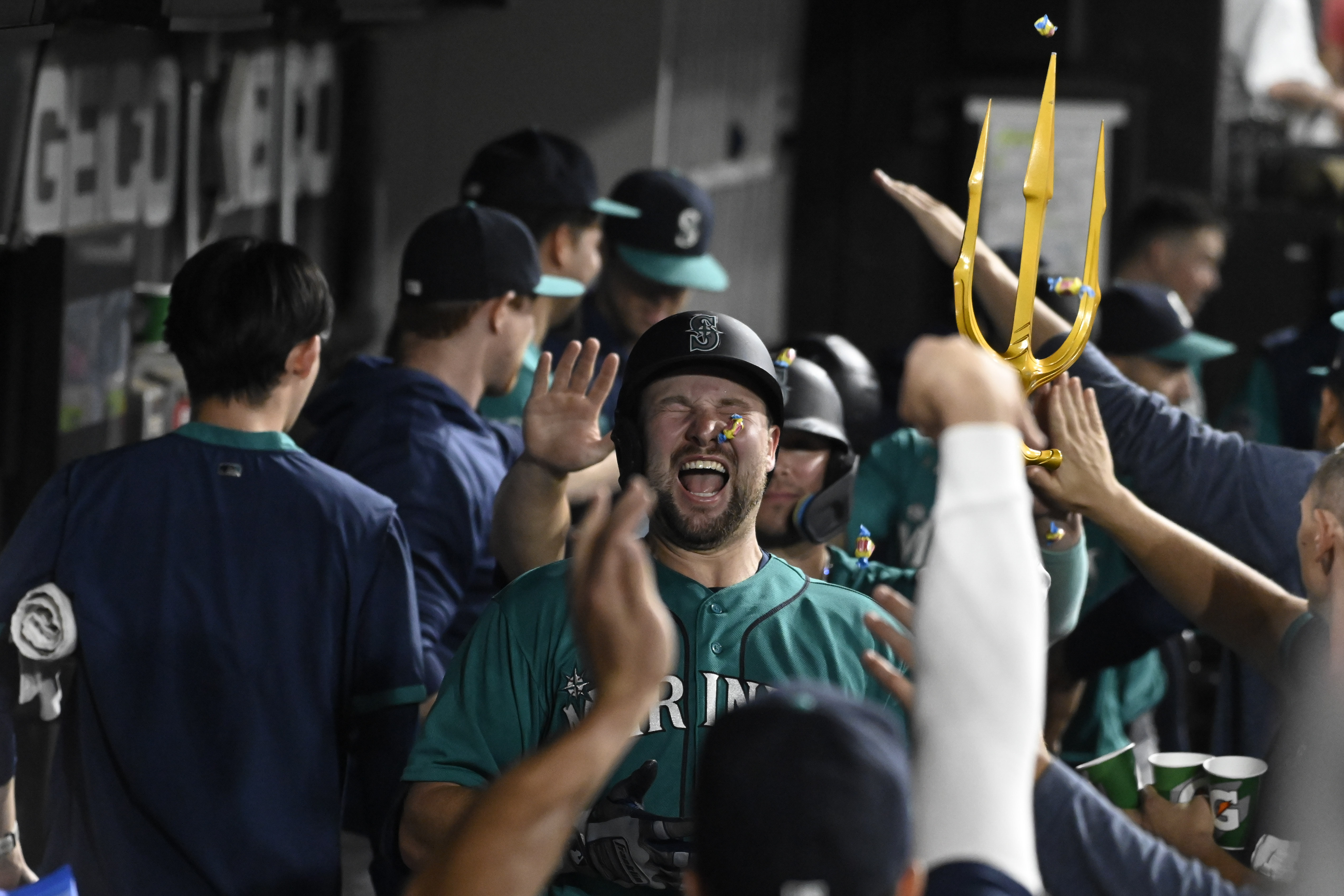 Seattle Mariners players embrace Home Run Trident