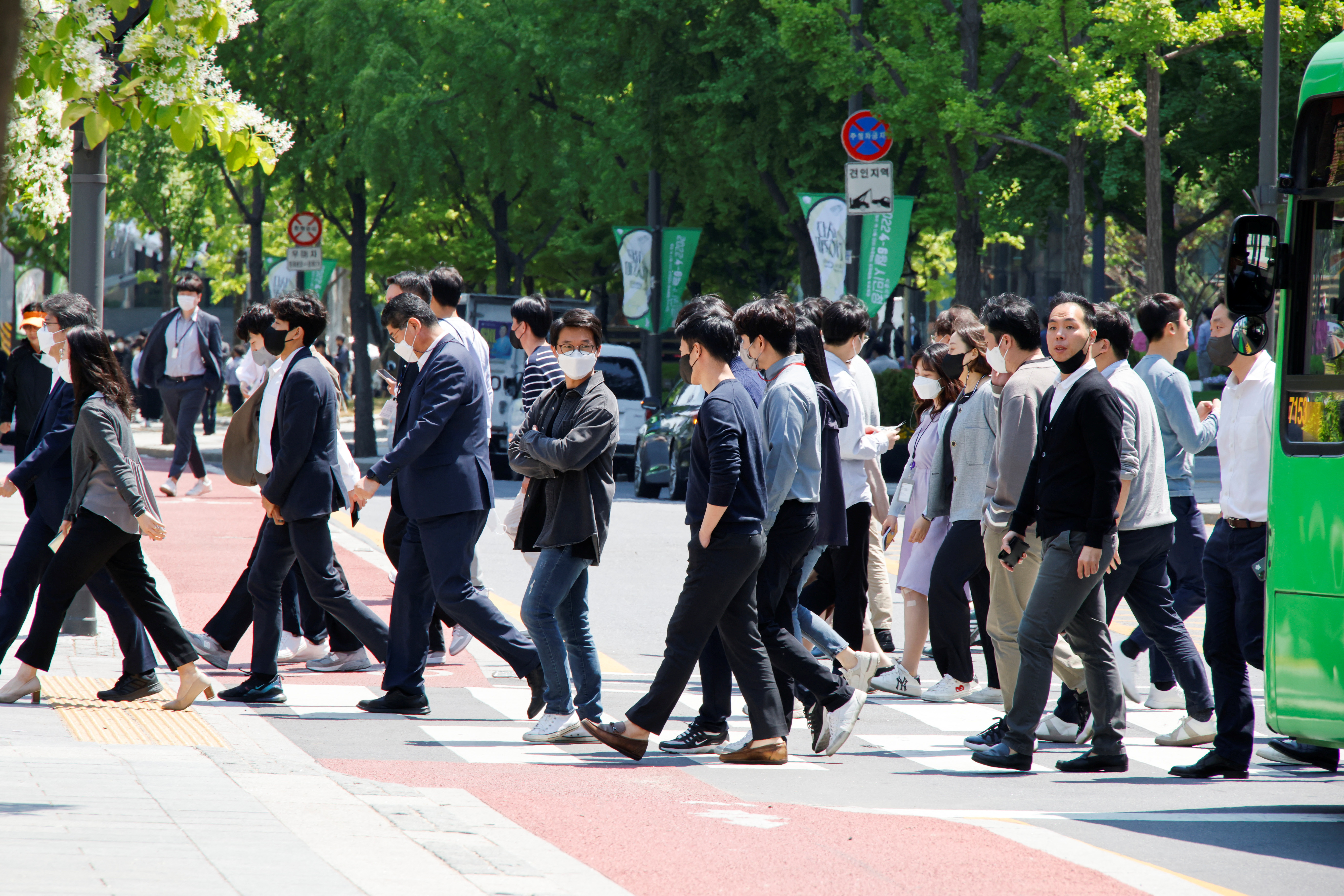 People wear masks to prevent the spread of the coronavirus disease (COVID-19) as they walk on zebra crossing in Seoul