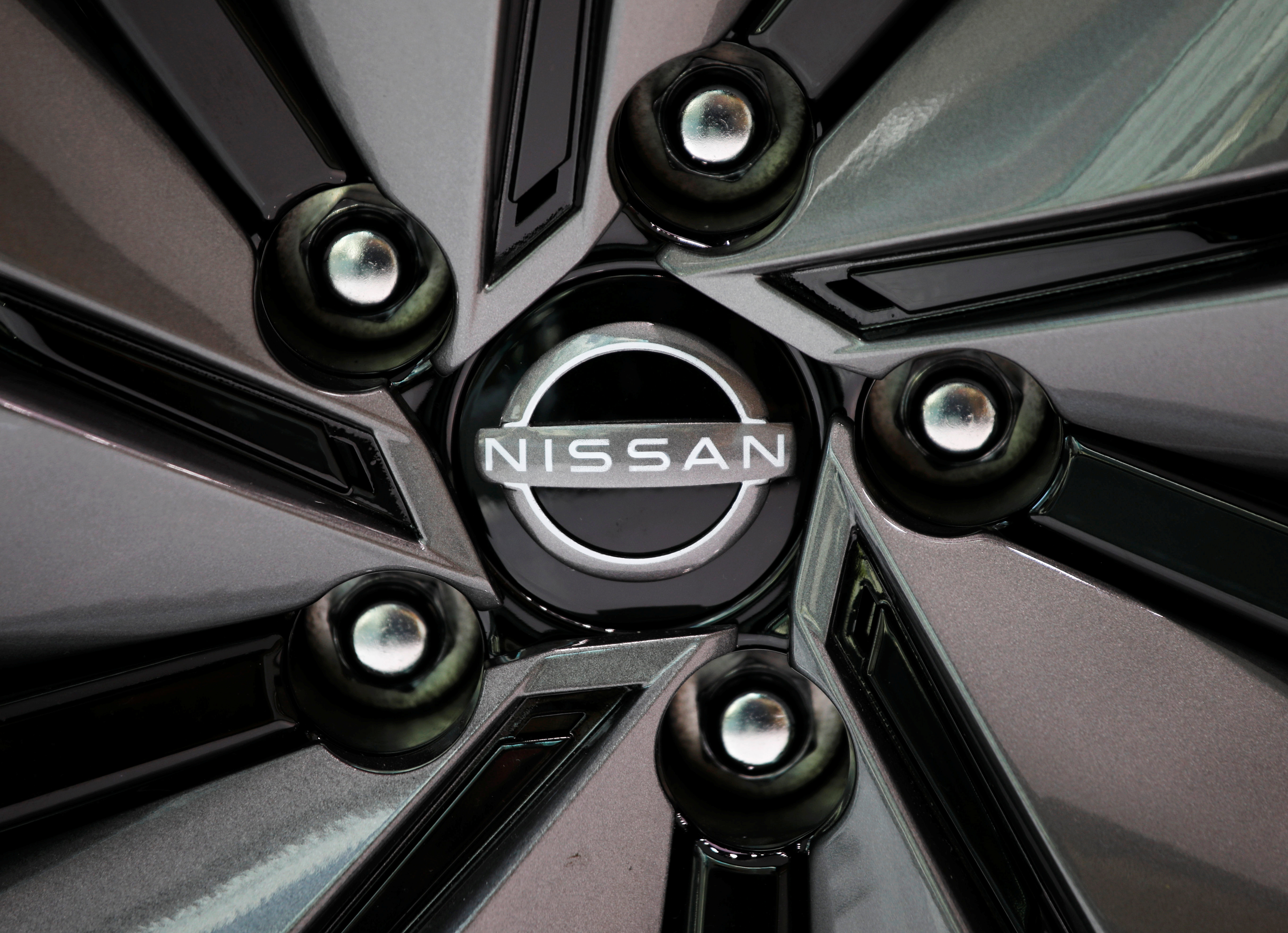 The brand logo of Nissan Motor Corp. is seen on a tyre wheel of the company's car at their showroom in Tokyo