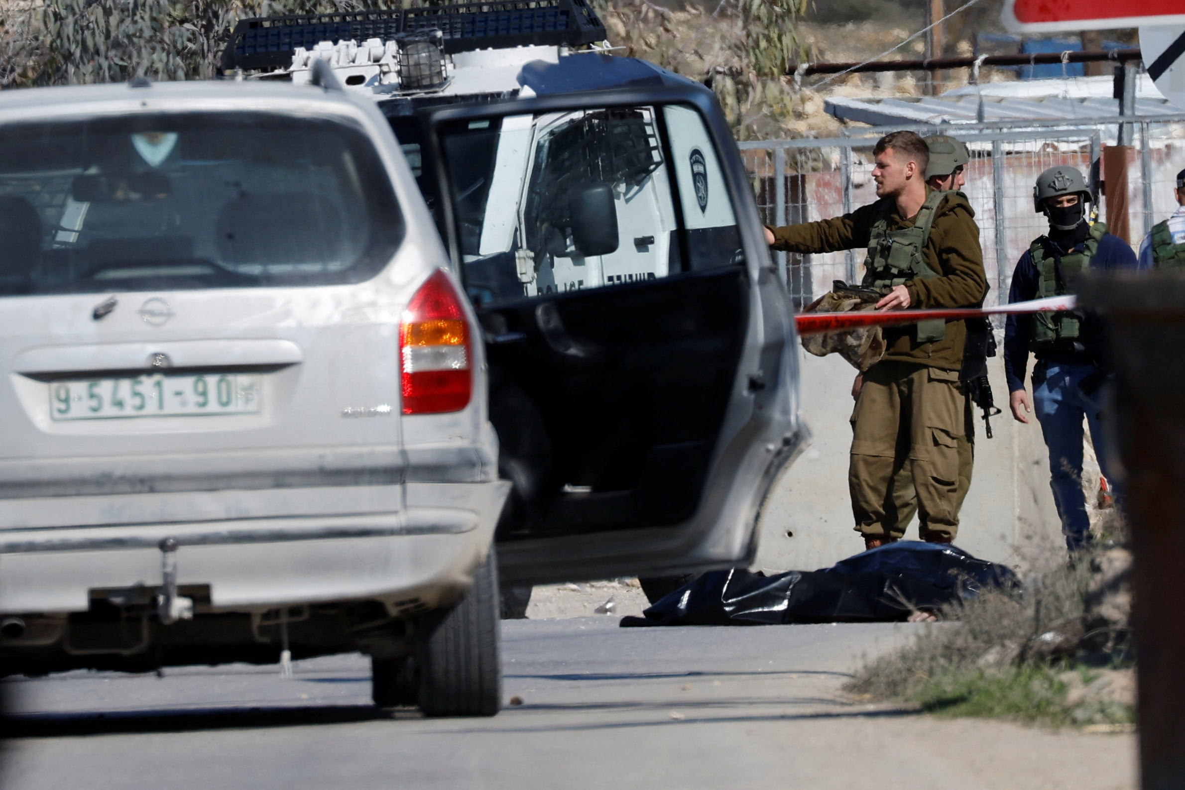 Israeli troops stand guard at the scene of the security incident near Hebron