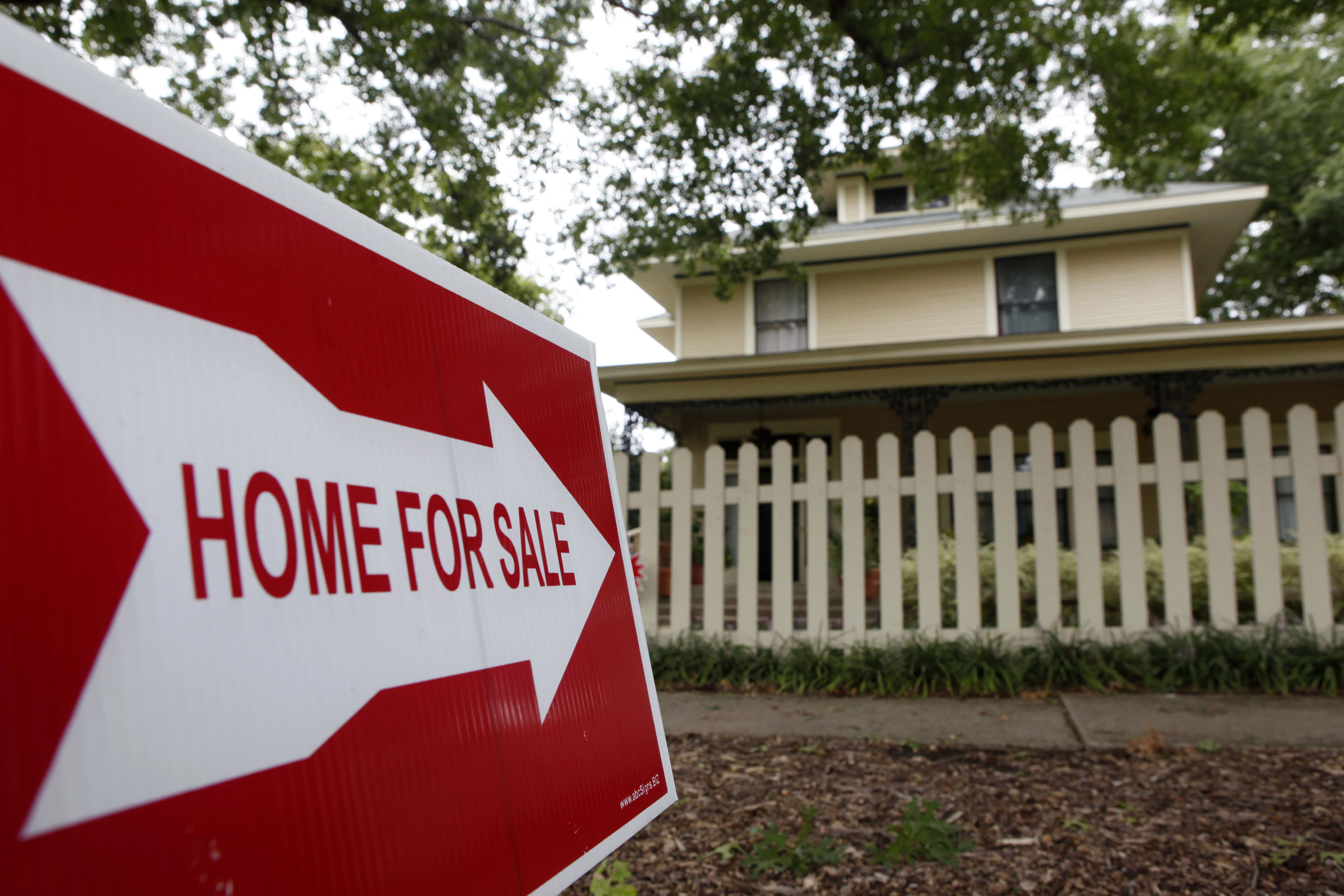 A sale sign points to a home in Dallas