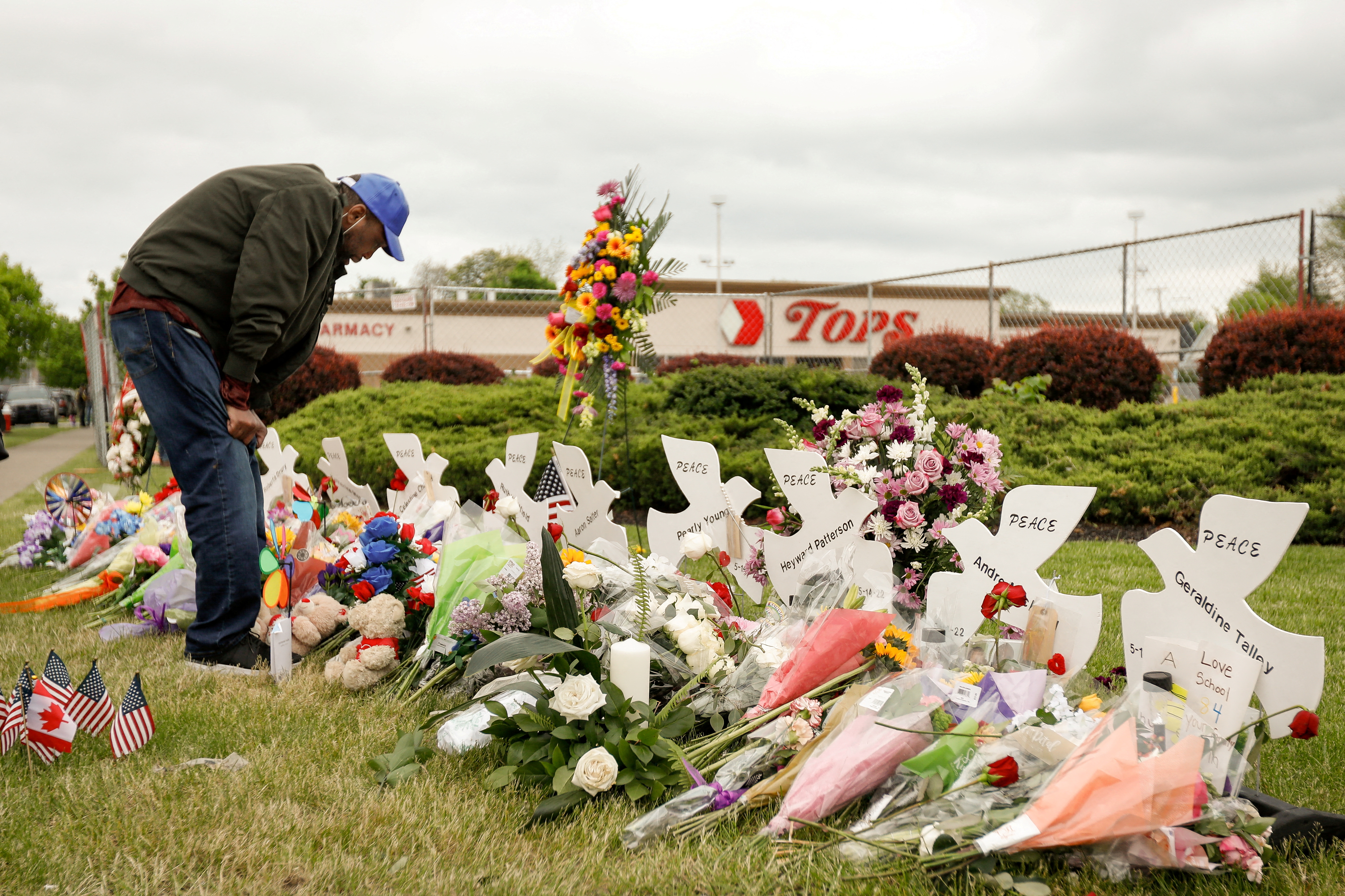 Man mourns at a memorial at the scene of a weekend shooting at a Tops supermarket in Buffalo, New York