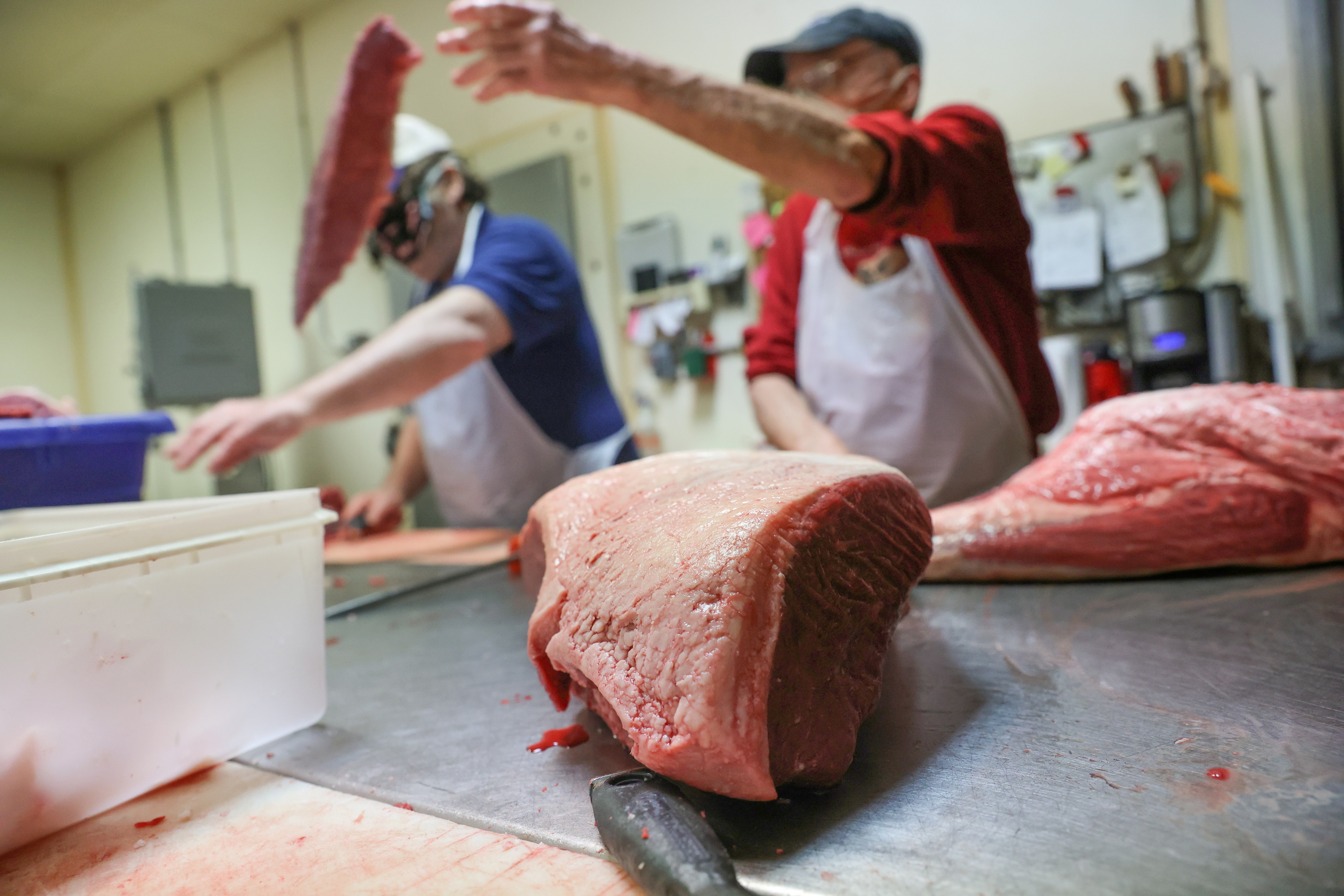 Meat is trimmed to be ground at a butcher shop in Pennsylvania