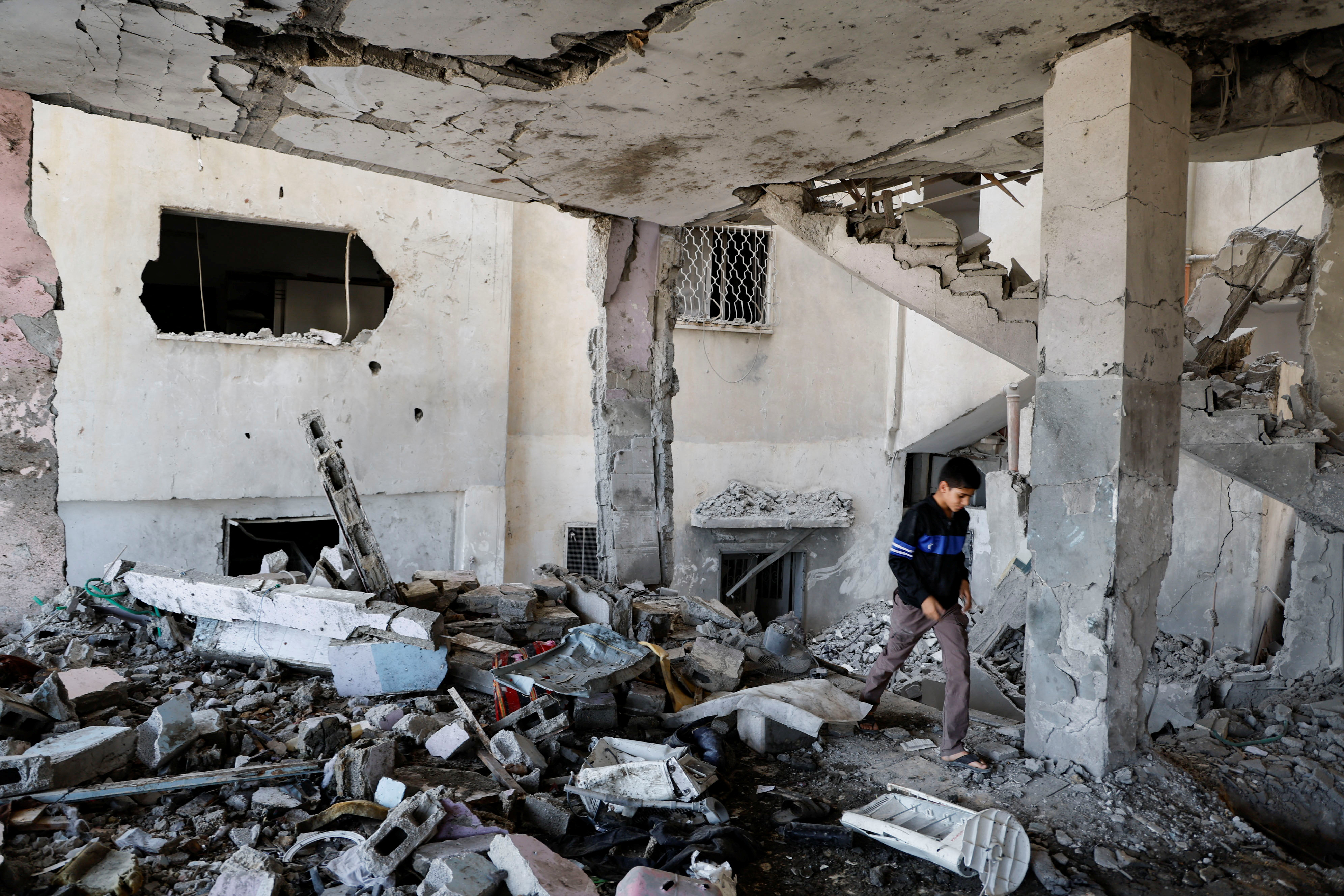 Palestinians check the damage at a mosque which was hit in an Israeli air strike, in Jenin