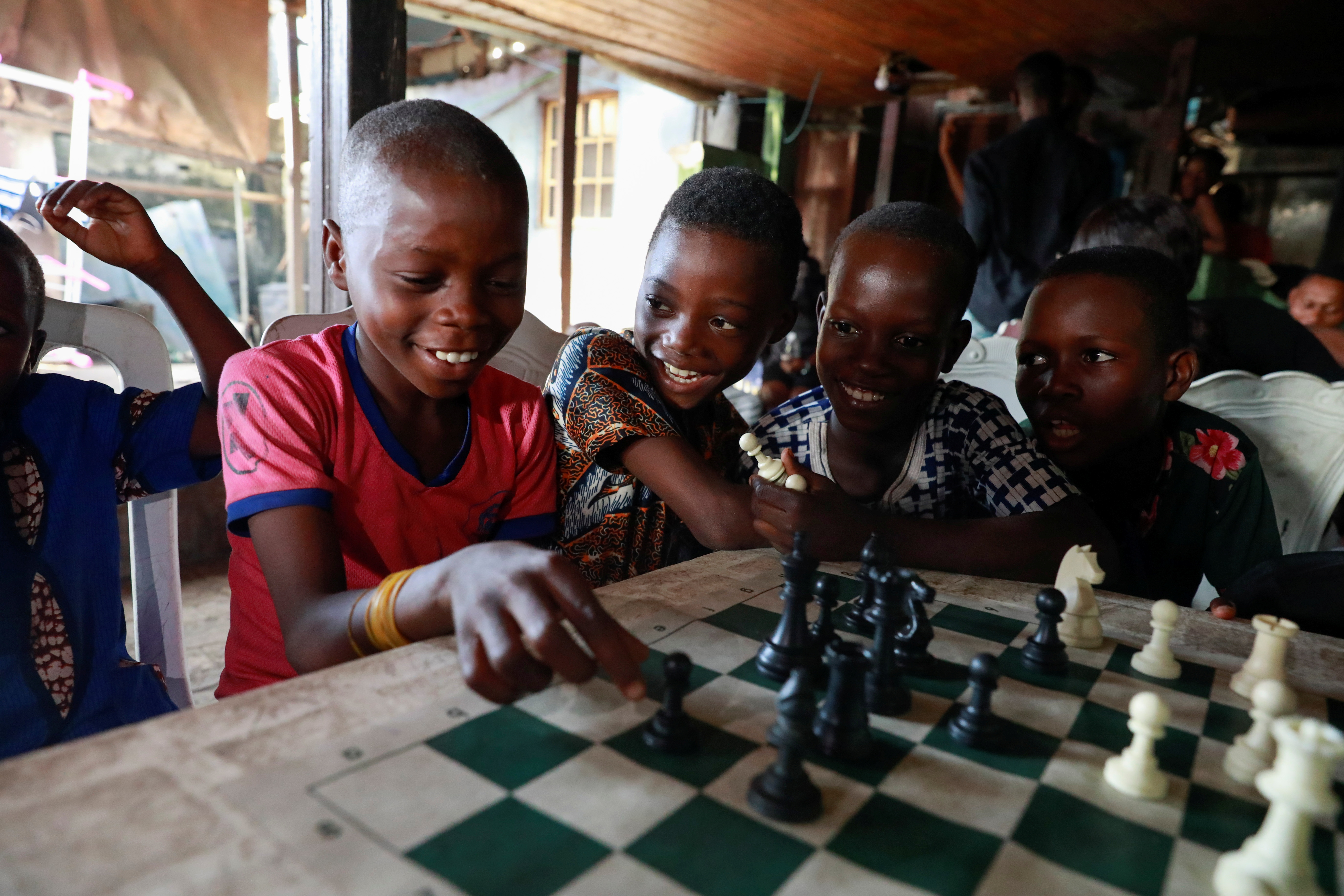 Children play chess at a community palace in Makoko, Lagos